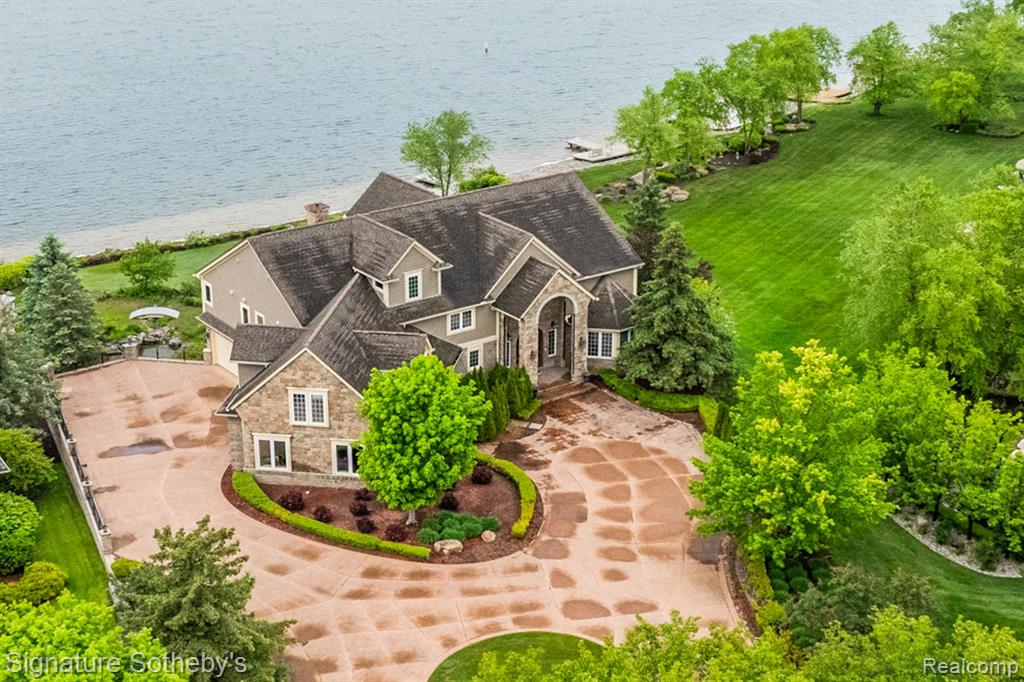 Magnificent, sprawling, custom built home ideally located with a panoramic lake view on Hidden Lake’s finest lot.  Intricate, stunning staircase leading to 2 primary suites with mood lit tray ceilings, fireplaces and balconies overlooking Hidden Lake. Hydronic in floor radiant heating throughout including driveway and sidewalks!  Main floor features a breakfast nook leading to the large deck with lake view.  Home features an elevator to reach each level and boasts a 6 car heated garage.  Wonderfully unique features including private home theater, indoor swimming pool, hot tub and sauna, sophisticated library and an elegant wine cellar amongst countless other stunning features.   Lower level with walk-out full kitchen, dance floor, gaming and workout area.  Beautiful landscaping adorns this idyllic lakefront home.