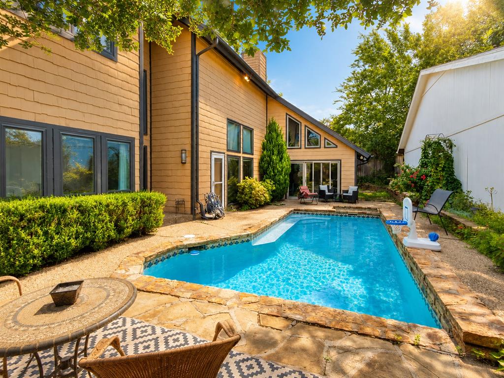 Welcome to 1615 Fox Hollow Ridge, a distinctive Contemporary Tudor tucked inside the desirable Oaks neighborhood. Located in Oklahoma City with OKC utilities and Edmond schools, this unique home offers privacy, convenience, and resort-style living.A secluded courtyard welcomes you into a home designed around a sparkling in-ground saltwater pool and attached hot tub, creating a peaceful retreat just steps from the main living areas. With minimal yard maintenance, you can spend more time relaxing, entertaining, and enjoying the outdoors.Inside, approximately 3,022 square feet is filled with incredible natural light from expansive windows and six skylights. Soaring vaulted and beamed ceilings, dramatic stained library paneling, and a cozy gas-log fireplace bring warmth, character, and architectural appeal to the main living area.The flexible floor plan includes 3 bedrooms, 3 full bathrooms, a charming loft, and two bonus spaces ideal for a home office, media room, gym, studio, guest space, or separate living area. A spiral staircase leads to the loft, while a second staircase near the kitchen provides added privacy to the upstairs bedroom, full bath, and bonus room.Major improvements include a new roof, newer HVAC systems, a tankless water heater, newer windows, fresh interior paint, remodeled upstairs bathroom, French drains, water softener, sprinkler system, and updated recessed kitchen lighting. Built-in appliances include the stove, oven, microwave, and trash compactor. With an acceptable offer, the refrigerator, washer, and dryer may remain.Conveniently located near the Kilpatrick Turnpike, I-235, and I-35, with easy access to Edmond and Oklahoma City shopping, dining, recreation, and employment centers. This is not a cookie-cutter home; it is a private sanctuary with flexible living space, abundant natural light, memorable architecture, and an exceptional pool courtyard.