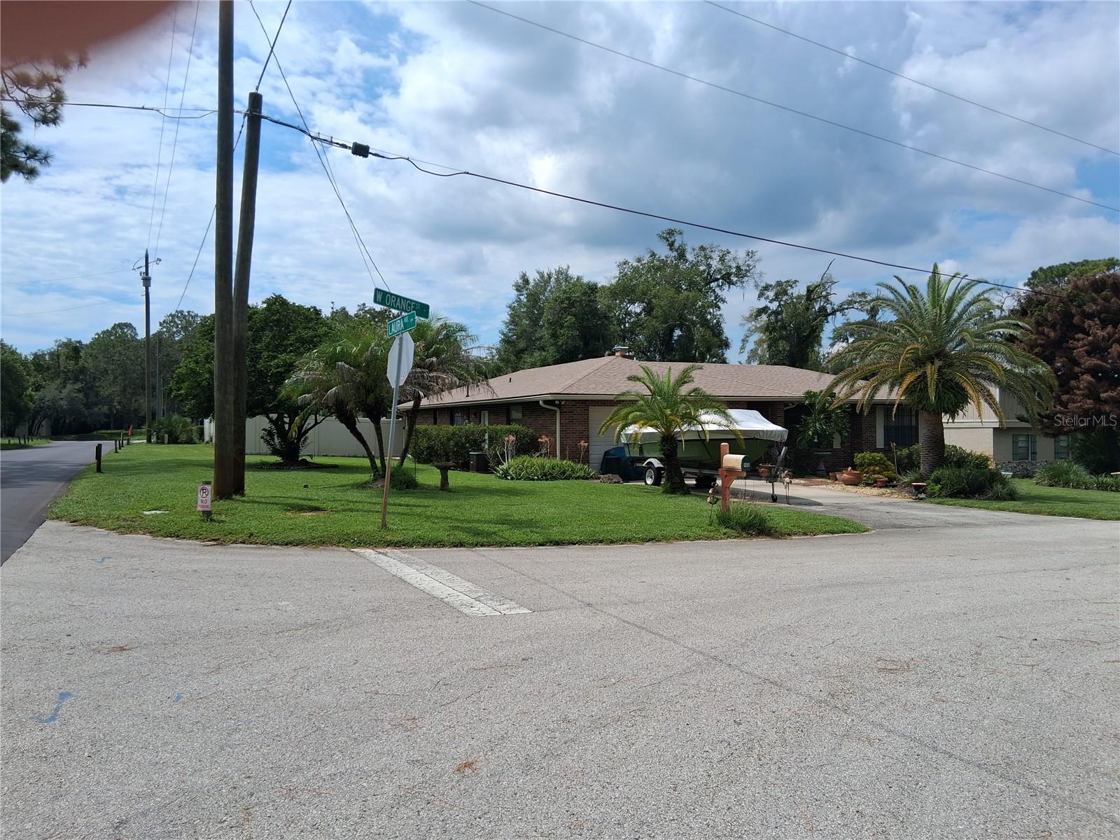 NO HOA!! Practically unheard of in this location. Brick hse, corner lot, over 1/3 acre. Very spacious back yard. plenty of room for the boat, trailer, lawnmower. (Corner spot for storage, partially fenced for em).1 small storage shed stays. No tiny pool here: in ground large pool. Inside you have a separate living room, mst bedroom on other end. Dining room separate but opens to l/rm. Kitchen (galley) in middle. One end opens to d/rm, other end opens to family room. Big wood burning fireplace in family rm. Wood stack slot next to f/place opens to back porch for easy loading. Beyond f/rm is 2 more bedrooms. Full bath in hall opens to hallway & a bedroom. On the b/porch of 28x11, plastic sliders. And per the owner, his property is located in the county, not city.