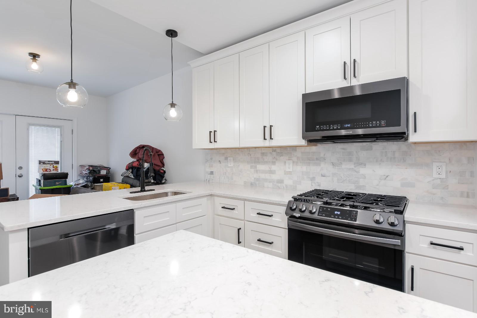 This move-in-ready rowhome offers the rare convenience of three primary suites, each with its own private en-suite bath. The bright, open main level features exposed brick, hardwood floors, recessed lighting, and a gourmet eat-in kitchen with quartz countertops, stainless steel appliances, gas cooking, a center island, and tile backsplash. A half bath completes the main level. The upper levels include two en-suite bedrooms with laundry on the first level and a private top-floor primary suite with a wet bar, mini fridge, rear deck, and Juliet balcony. The partially finished lower level provides flexible space for an office, den, or storage. A perfect blend of modern updates, functional living, and city convenience!Monthly rent is priced at $3,800/month; first month's rent and one month security deposit are required to move in ($7,600.). Utilities are not included in the price. Verifiable income of at least 3x monthly rent and a minimum credit score of 650 are required to qualify. Pets are allowed and will be considered on a case-by-case basis.