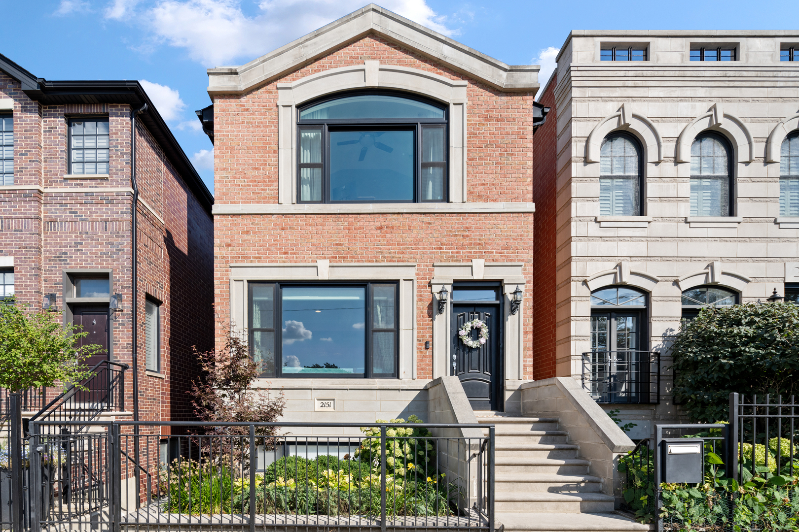 Perfectly positioned in the heart of Bucktown, directly across from Holstein Park, this stunning 4-bedroom, 3.1-bath full masonry home offers the ideal blend of elegance, comfort, and city convenience.  Step inside to a sun-drenched living room highlighted by a charming picture window overlooking the park and a cozy wood-burning fireplace, seamlessly flowing into a sophisticated dining area. The chef's kitchen is designed for both everyday living and entertaining, featuring abundant cabinetry, a full pantry, expansive counter space, an eat-in breakfast bar, and a central island that opens into the spacious family room. Sliding glass doors extend the living space outdoors to a large Trex deck-ideal for grilling and al fresco dining-with stairs leading up to a beautifully appointed garage roof deck with pergola. Upstairs, discover three bright bedrooms, including a luxurious primary suite with generous closets and a spa-inspired bath boasting a soaking tub, oversized shower, dual vanities, ample storage, and natural light from a skylight. The two additional bedrooms share a thoughtfully designed bathroom with double sinks and a separate shower/toilet area. The lower level offers exceptional versatility with a sprawling recreation room, gas fireplace, built-in bar with wine fridge, storage closets galore, and space for relaxing or entertaining. A fourth bedroom with a full bath makes an ideal guest suite or home office. Additional highlights include a large laundry room, grand mud area, irrigated front lawn and a two-car garage. Enjoy the vibrant Bucktown lifestyle just outside your door, with Holstein Park's pool, playground, and green spaces serving as an extension of your backyard, plus easy access to the Blue Line for seamless commuting.