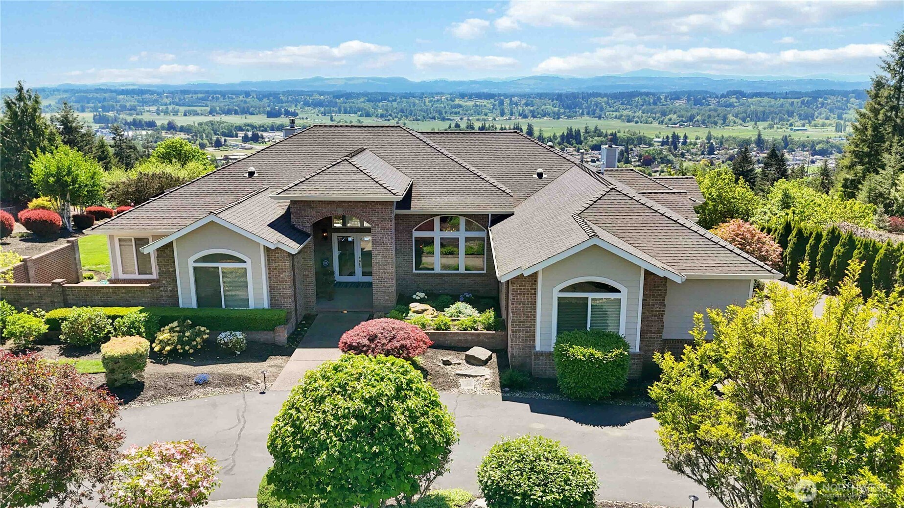 Welcome home to the gated community of Alderwood Heights, where quality craftsmanship meets breathtaking views. This stunning 4-bedroom plus den, 2.5-bath home offers just shy of 4,000 square feet of thoughtfully designed living space.  The formal living room welcomes you with a cozy fireplace and French doors opening to a covered, spruce-ceiling patio — the perfect spot to take in the view. The spacious primary suite also opens directly to the patio and features a spa-like bath with a custom closet, tiled shower, double sinks, and a jacuzzi tub.  The kitchen is a chef's dream, complete with double ovens, Corian countertops, walk-in pantry, and a sunny breakfast area. It flows into the family room, anchored by a fireplace with custom built-in cabinetry. A formal dining room offers additional space for entertaining.  A private den with built-in cabinets and French doors to its own courtyard offers a quiet retreat or home office. Additional features include a sound system, rope lighting above cabinets, security system, central vac with toe-kick inlets, dual-zone HVAC with electronic air filtration, and double gas water heaters.  Outside, enjoy a beautifully landscaped yard with exterior lighting and a full sprinkler system, plus a 3-car attached garage with abundant bonus storage.