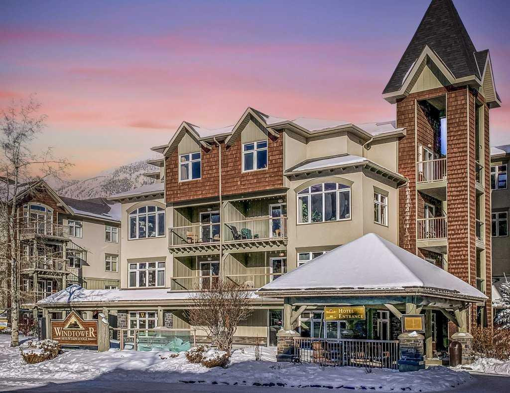 Mountain Investment with Airbnb Potential in Canmore: Turn-key 1-bedroom hotel condo in the popular Windtower Lodge, ideally suited for investors, vacation-home buyers, and those seeking a flexible mountain lifestyle. The Tourist Home zoning permits self-managed or third-party managed short-term rentals, including Airbnb, while also allowing long-term rentals or full-time living—offering exceptional ownership flexibility.Located on the 3rd floor, this bright southwest-facing unit enjoys attractive mountain views from the private balcony. The well-appointed kitchen features stainless steel appliances, including a refrigerator, Ceran-top electric stove, and brand new dishwasher. The suite is offered fully furnished and equipped, complete with TV, cozy fireplace, in-suite laundry, electronic doorlock, and all furnishings included, making it rental-ready from day one. The existing sofa can easily be replaced with a sofa bed to accommodate up to four guests and maximize rental potential.Additional highlights include a titled underground parking stall, secure building access, fitness room, and a brand-new dual spa deck currently under construction. Conveniently located within walking distance of downtown Canmore's restaurants, shops, trails, and attractions, this is an excellent opportunity to own a revenue-generating mountain property in one of Canada's most desirable tourism markets.