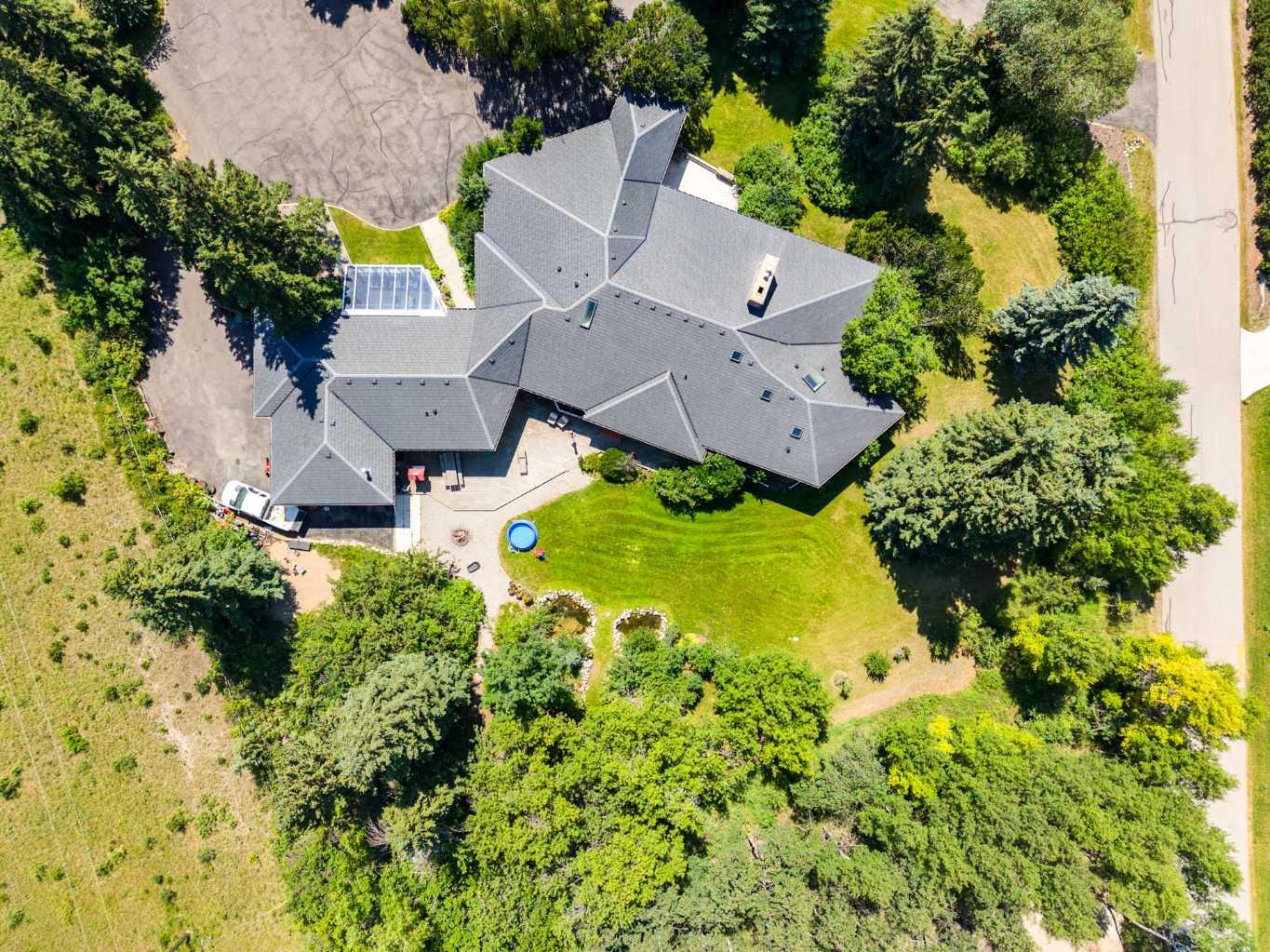 MOUNTAIN VIEWS | EXCEPTIONAL DEVELOPMENT OPPORTUNITY | THE SLOPES OF SPRINGBANK HILL | Rare opportunity to acquire a prime 4-acre parcel in one of Calgary’s most sought-after west end neighbourhoods. Featuring two existing driveways and two municipal addresses, this expansive site offers outstanding potential for subdivision and future development. Ideally positioned within The Slopes of Springbank Hill, the property boasts sweeping ROCKY MOUNTAIN VIEWS, full of lush mature trees, privacy and is surrounded by prestigious estate homes. Preliminary potential exists for up to eight 0.5-acre lots (subject to City of Calgary approval), making this an excellent opportunity for developers, builders, or long-term investors seeking a strategic land holding.  This is perfectly suited for luxury estate homes or boutique custom development.  The property is priced based on land value only; however, the existing home is large, updated, fully livable, and wheelchair accessible. Interior photos are available upon request. All development and land use changes are subject to approval by the City of Calgary. This is one of the last remaining large parcels in this highly coveted west-end. ***Private showings by appointment only. Please do not walk the property without an appointment.*** ASK US ABOUT THE CURRENT PLANS SUBMITTED FOR SUBDIVISION FOR MORE INFORMATION!