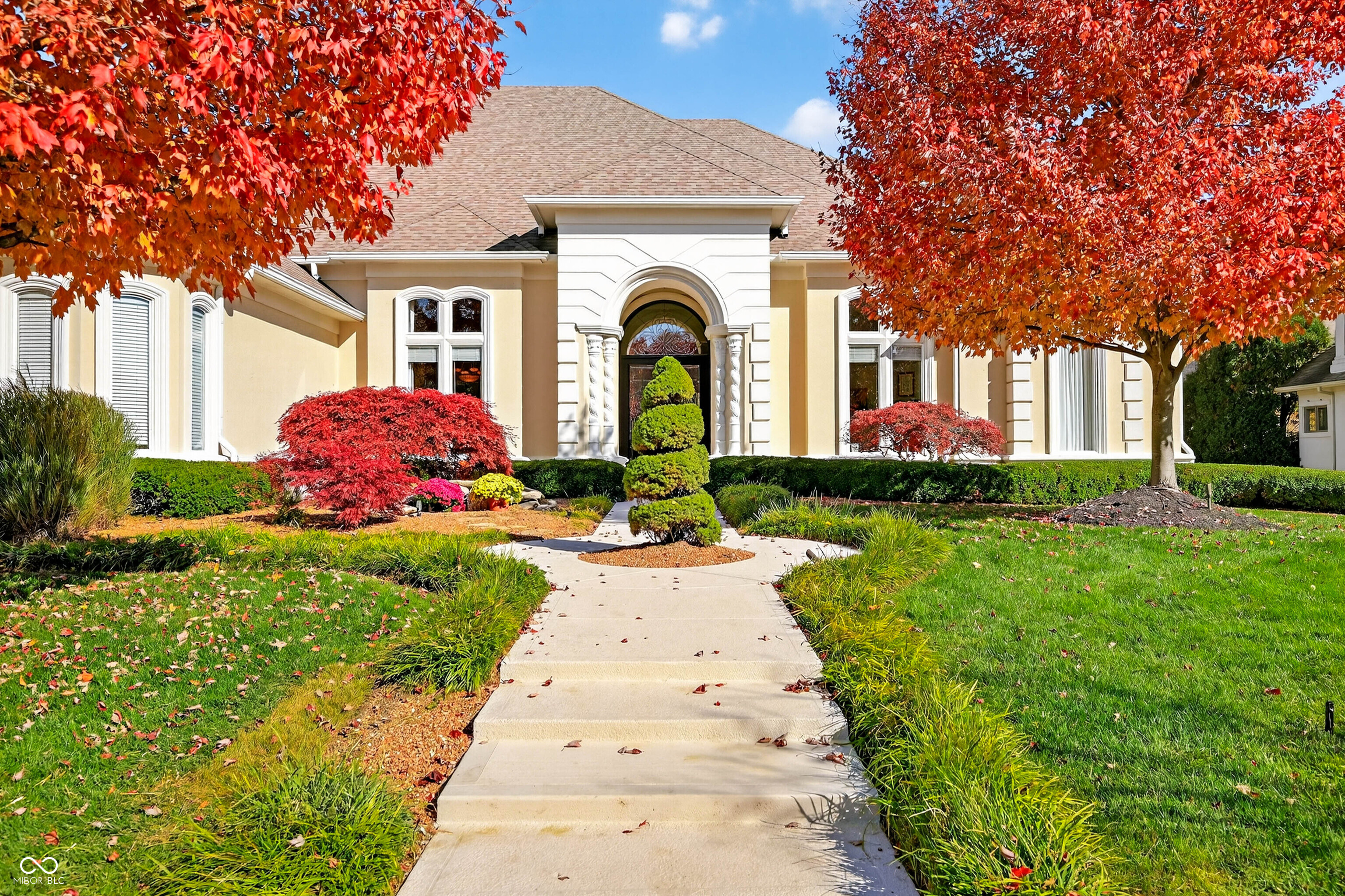 Experience refined luxury and timeless design in this award-winning custom estate by renowned builder Greg Allen-recipient of the 1998 Home-A-Rama "People's Choice" Award. Perfectly positioned in the heart of Center Grove, this residence blends masterful craftsmanship with sophisticated modern updates to create an unparalleled living experience.  Step inside to soaring 14' ceilings, rich architectural detail, and expansive living spaces designed for both grand entertaining and everyday elegance. The newly remodeled kitchen serves as the home's showpiece-featuring premium finishes, generous prep space, and a seamless flow into the main living areas.  With 4 spacious bedrooms, each offering walk-in closets, and 4 full baths plus 2 half baths, the home provides exceptional comfort and privacy for family and guests.  The fully finished 3,450 sq. ft. walkout basement is its own retreat-complete with a full theater room, private exercise room, and a stylish wet bar. Whether hosting game nights, movie marathons, or weekend gatherings, this space delivers endless opportunity.  Outside, your personal resort awaits. Nestled on nearly half an acre, the backyard features a sparkling in-ground pool, multiple outdoor living areas, and lush privacy-creating the ultimate setting for summer entertaining and peaceful relaxation.  A rare combination of elegance, quality, and livability, this Center Grove luxury home offers the lifestyle you've been dreaming of-crafted with intention, updated with care, and designed to impress at every turn.