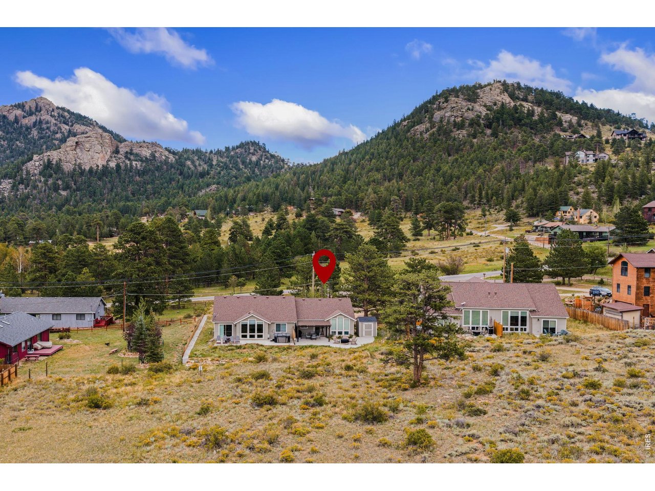 Imagine waking up to the crisp, fresh pine air, pouring a hot cup of coffee, and stepping outside to watch the morning light paint the peaks of Rocky Mountain National Park. Welcome to 1553 Marys Lake-a charming mountain getaway where every day feels like a long-awaited weekend retreat. Tucked into a prime location right between Marys Lake and the heart of town, this home perfectly balances secluded mountain serenity with total convenience. The moment you step inside, the open floor plan welcomes you in with an abundance of natural light and framed mountain views right through the windows. Designed for easy living and effortless main-level flow, it's a space built for unwinding after a day on the trail. The cozy living area seamlessly connects to a open dining space and functional kitchen. But the real magic happens out on the back patio. Your outdoor living area offers sweeping, unobstructed views of the surrounding Rockies. Whether you're grilling dinner, sitting around the fire pit, or watching the local wildlife pass through the meadow, this setting is pure Colorado magic. When it's time to call it a day, the primary suite offers a quiet haven complete with its own private bath. An additional bedroom and bathroom give you all the versatility you need for hosting guests or setting up a home office. Best of all, you are just minutes away from the Beaver Meadows and Moraine Park entrances of Rocky Mountain National Park, as well as local coffee shops, craft breweries, and downtown dining. For investors, this property comes with a proven track record as a successful short-term rental, situated in accommodation zoning-giving you the rare peace of mind of a transferable license. Whether you're looking for a full-time mountain sanctuary, a low-maintenance lock-and-leave basecamp, or a turnkey income-producing retreat, this home is completely ready for its next chapter. Welcome home!