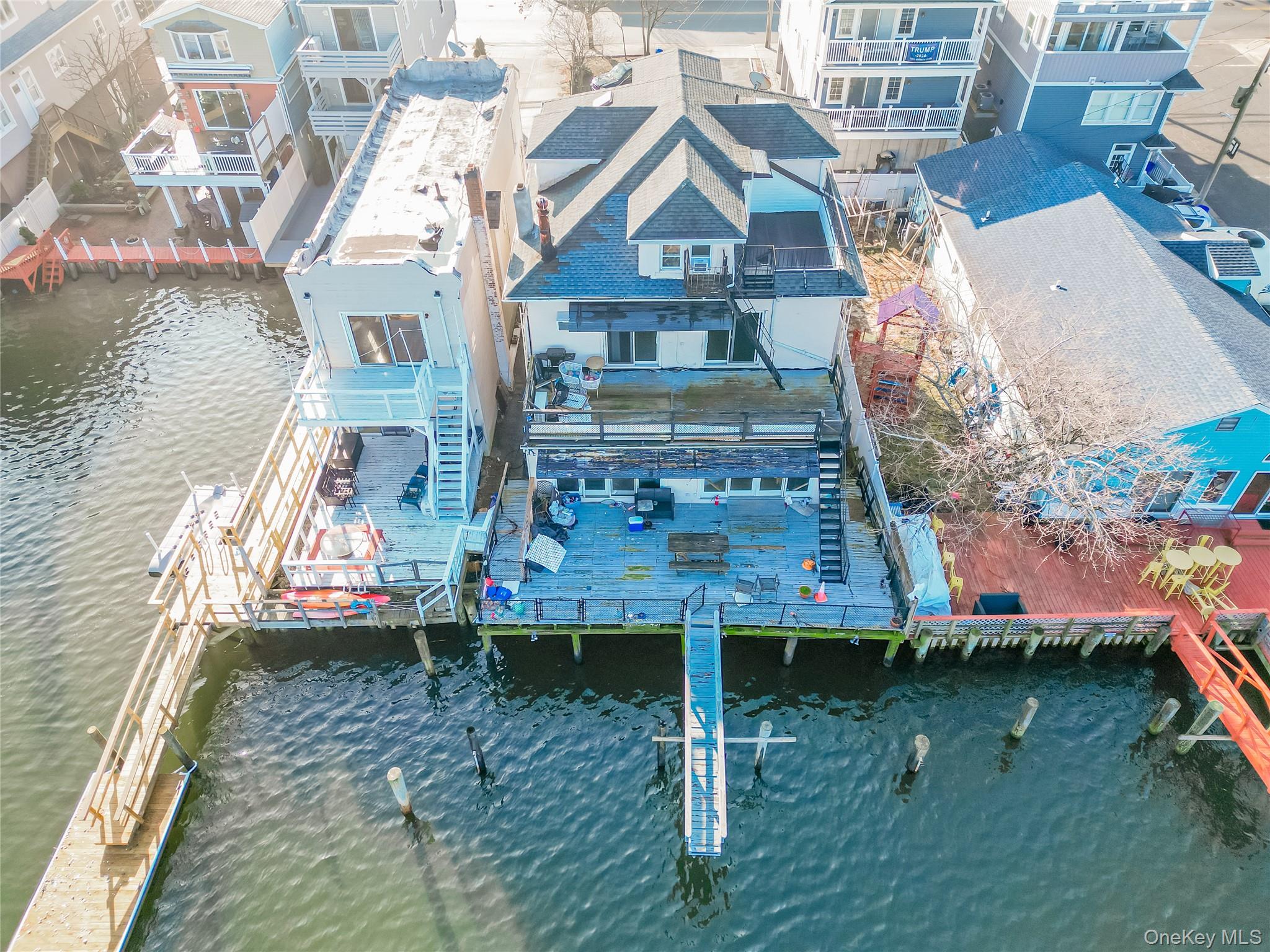 Set on a large waterfront lot with breathtaking, unobstructed views, this expansive five-bedroom, four-bath residence offers over 3,400 square feet of living space and exceptional potential. The home’s generous layout, abundant natural light, and prime water frontage create a rare opportunity to design a truly spectacular retreat tailored to your vision. While the property is in need of updating and renovation, the bones, scale, and setting provide an outstanding foundation for transformation. With thoughtful investment, this home can be reimagined into a show-stopping waterfront estate—perfect for luxurious everyday living or an impressive vacation escape. Opportunities like this, combining size, location, and view, are increasingly rare. Bring your imagination and unlock the full potential of this remarkable property.