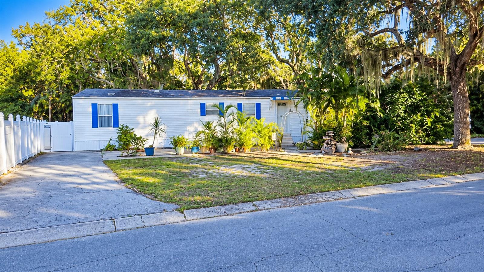 OWN THE LAND! FULLY FURNISHED! PRIVATE POOL! LOW $52 MONTHLY HOA!Welcome to 1301 Live Oak Parkway, located in the charming, all-ages Leisure Lake Village community of Tarpon Springs! This 2003 manufactured home features 2 bedrooms, 1 full bathroom, and 728 square feet of living space. SOLD FULLY FURNISHED, with existing furniture conveying with the sale, this property offers an affordable, move-in-ready opportunity to enjoy the Florida lifestyle!Step inside to a welcoming living area with natural light and a functional floor plan. The kitchen, updated in 2020, features cabinetry, countertops, stainless steel appliances, ample storage, and a convenient breakfast bar. Both bedrooms provide comfortable accommodations, while the indoor laundry area with washer and dryer adds everyday convenience.MAJOR IMPROVEMENTS INCLUDE: ROOF (2020), HVAC (2019), WATER HEATER (2020), KITCHEN CABINETRY AND COUNTERTOPS (2020), REFRIGERATOR AND STOVE (2020), GENERATOR ELECTRICAL SETUP (2020), PRIVACY FENCING (2020), and ABOVE-GROUND SWIMMING POOL (2020).Enjoy your own PRIVATE OUTDOOR RETREAT, featuring an above-ground swimming pool, spacious wooden deck, fenced outdoor areas, and beautiful tropical landscaping surrounded by mature oak trees. The property also includes a DETACHED, AIR-CONDITIONED SHE-SHED (2020), ideal for a hobby room, home office, creative space, or additional storage.An added benefit is the EXTRA PARKING AREA BEHIND THE HOME, offering flexibility for additional vehicles, recreational equipment, or a small trailer, subject to community guidelines.NO LOT RENT — YOU OWN THE LAND! Enjoy an affordable monthly HOA of approximately $52 and a location in Flood Zone X, where flood insurance is generally not required.Residents of Leisure Lake Village enjoy a peaceful neighborhood setting near beautiful Salt Lake, with community fishing pier and boat-launch access offering opportunities for fishing and water recreation.PRIME TARPON SPRINGS LOCATION! Just blocks from the scenic Pinellas Trail and minutes from Historic Downtown Tarpon Springs, the famous Sponge Docks, local restaurants, shopping, and entertainment. Beautiful Fred Howard Park and Sunset Beach are a short drive away, while nearby US Highway 19 provides convenient access to Palm Harbor, Dunedin, and surrounding Tampa Bay communities.Whether you’re looking for a primary residence, seasonal getaway, or affordable second home, this property combines valuable improvements, versatile outdoor living spaces, low monthly fees, and a desirable location.DON’T MISS THIS OPPORTUNITY TO OWN YOUR PIECE OF FLORIDA PARADISE — SCHEDULE YOUR PRIVATE SHOWING TODAY!