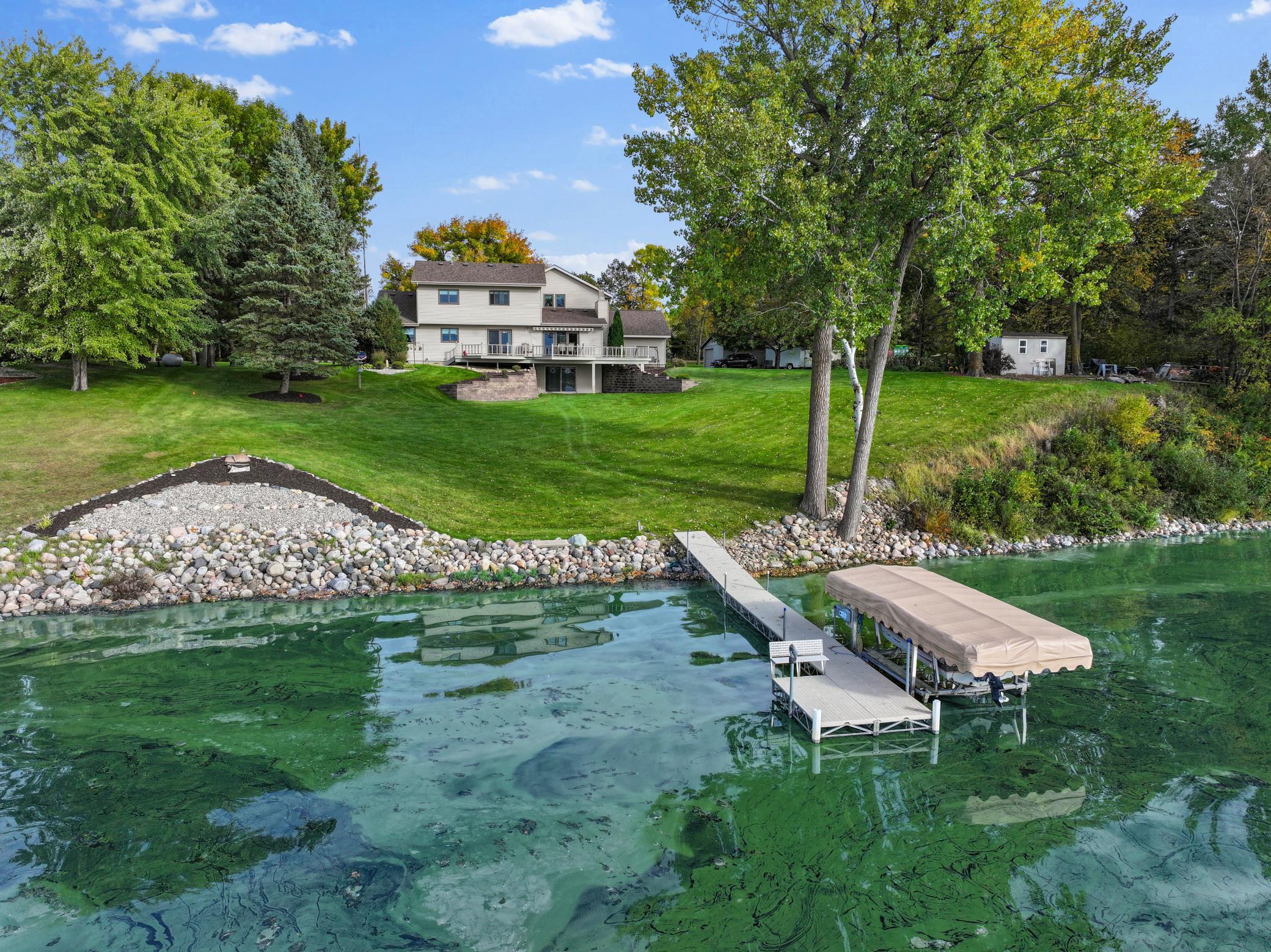 Welcome to this pristine, meticulously maintained home on Sauk Lake, offering 200 feet of prime lake frontage and breathtaking western views that capture the sunsets every evening. Situated on 2.10 acres of land, this property delivers panoramic water views from nearly every angle. Inside, you'll find 3 spacious bedrooms and 4 bathrooms spread across 3,341 square feet of living space. Vaulted ceilings create an airy, open feel, while the owner's pristine care and attention to detail are evident throughout. The kitchen comes complete with new stainless-steel appliances, adding modern convenience to the home's classic charm. This is a home that has been loved and maintained to the highest standard. The property is complemented by outstanding amenities, including a 3-stall attached heated garage with an epoxy floor and an oversized 1-stall, heated, detached garage/workshop — perfect for hobbies, storage, or projects. A tar road with a horseshoe driveway provides easy access, while mature trees and a large garden add private, natural beauty to the setting. Step outside to a wrap-around deck with a SunSetter retractable awning, the ideal spot to relax and take in the panoramic lake views. A gradual slope leads you down to the lake for easy water access. Built in 1984, this two-story home blends classic construction with modern comfort in one of the area's most desirable lake settings. Schedule your private showing today!