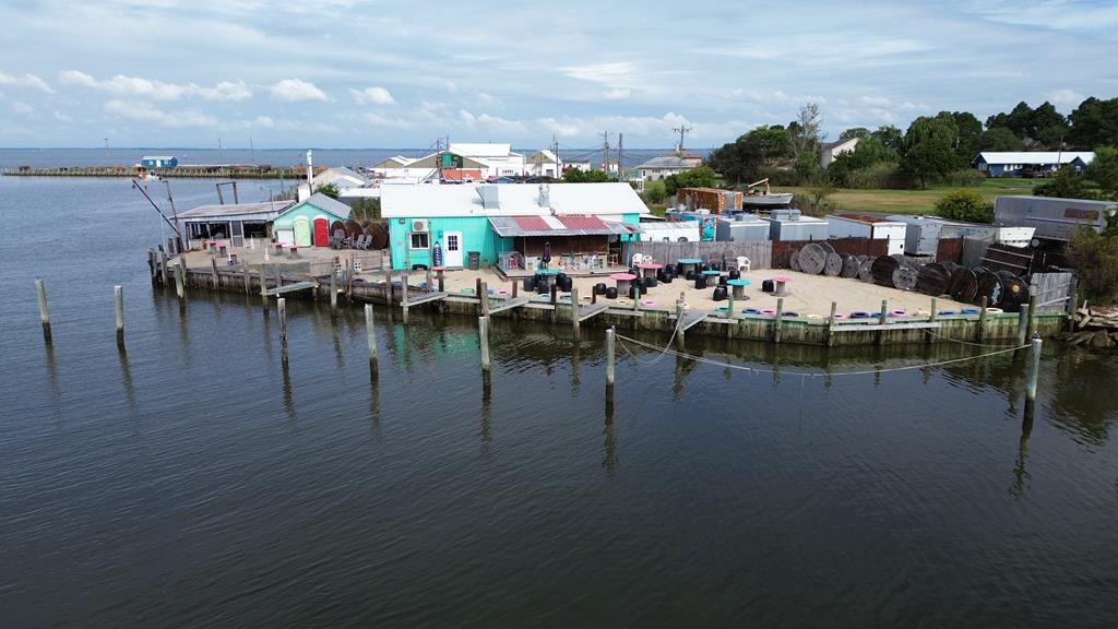 REDUCED! What are you waiting for?! Imagine smelling the salt air while checking out the view, life doesn't get any better than this! Capt. E's Hurricane Grill is a well established waterfront restaurant & outdoor TIKI BAR! Approx 425' of waterfront overlooking the harbor, Pocomoke Sound & Chesapeake Bay. Restaurant/Bar is turn key with 15 BOAT SLIPS! Four soft crab aqua farm beds. Food Truck CONVEYS! Main building with kitchen, booth dining seating, 2 restrooms & bar. There is an outside bar right out of Margaritaville with additional seating & your toes in the sand & covered dining space. Additional building on site, storage or possible expansion. 2 outdoor coolers. Restaurant is open for business, advance appt needed. 37 55"08.24"N 75 43'39.40"W come in by boat, town ramp coordinates