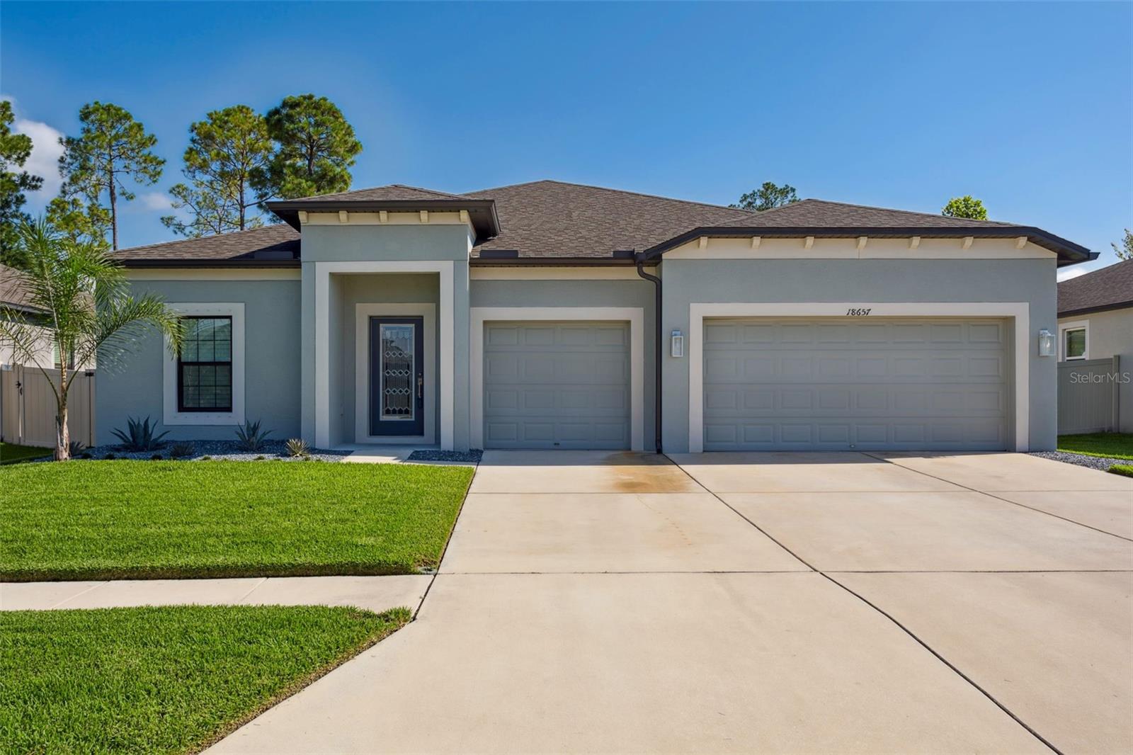 The best of the best, like new, immaculate from top to bottom this 4 bedroom x 3 bathroom x 3 car garage offers the perfect home for a buyer
with higher expectations. Property is totally fenced with a large backyard, big enough to built your dream pool, outdoor kitchen and playground. A minimalistic and low maintenance landscaping welcoming you into the house. As you enter the home you will find the first two bedrooms that share one spacious bathroom on the left. To the right are the doors that lead to the 3-car garage, a large storage closet and the sophisticated laundry room. The garage features an epoxy floor, upgraded LED lighting, modern ceiling fans, garage door insulation and a whole water and softener purification system. Moving forward to the entry hall the house opens to the great room which shares space with the newly upgraded gourmet kitchen. The gourmet kitchen features stainless steel appliances, new sparkling white quartz countertops, large single bay sink, new faucet, new modern glass backsplash, and built in custom shelving in the pantry. All the bathrooms have new quartz counter tops, sinks and faucets. The kitchen connects to the family room and the dining room that features plantation shutters. The sliding doors have automated blinds and take you to the large fenced backyard with a covered patio (which would be perfect for the pool!). Opposite to the kitchen is the primary suite with plantation shutters, a fully upgraded walk-in closet that has custom built in shelving and spa style bathroom. The 3rd spare bedroom and bathroom are next to the primary suite and also include custom closet shelving. All light features inside and out in this home have been upgraded and are modern LED, many including dimmers. Great location just in the path of upcoming growth, close to Land O'Lakes Blvd and SR-52.
