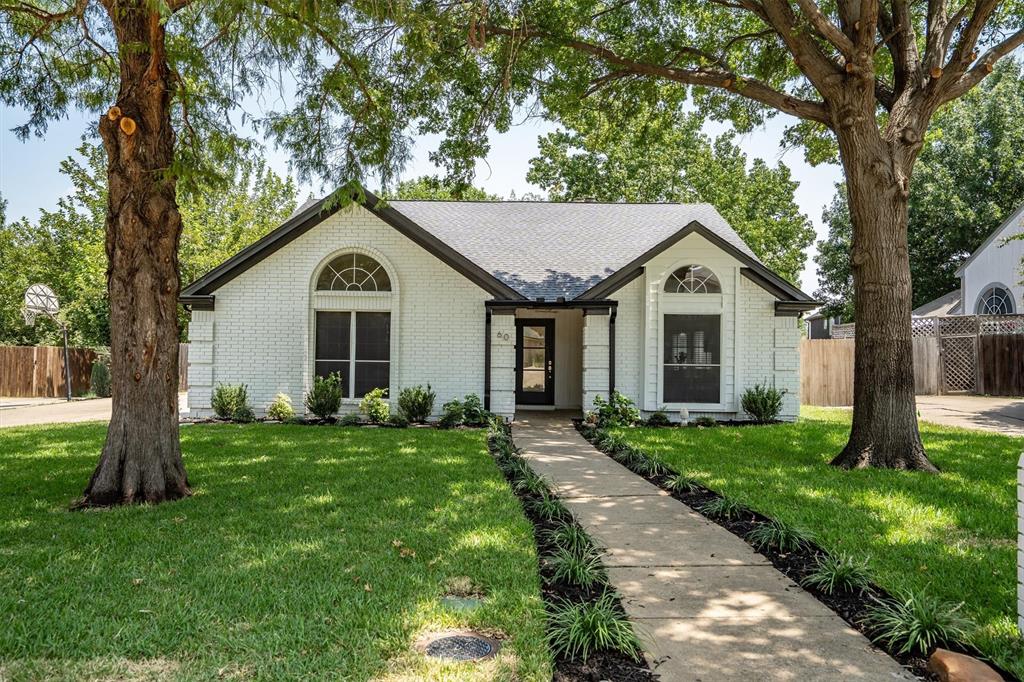 Beautifully & Completely UPDATED 3 bed, 2 bath open concept home in Northwest ISD.  2025 updates include an updated kitchen with  stunning quartz countertops, white kitchen cabinets complete with champagne gold hardware, designer light fixtures, and a wine fridge. Secondary & primary bathrooms have been completely remodeled with a frameless shower and stand alone tub. Gorgeous light oak LVP flooring throughout the whole house (no carpet), cedar beams in living areas and primary bedroom, stunning living room fireplace makes for a gorgeous and updated statement, fresh interior paint, white painted exterior brick, new sod and landscaping, and much more. Perfect location: 1 block from the elementary schools and playing fields, less than 1.5 miles to parks, swimming, all grade level schools, as well as dining and shopping. Independence Park, which offers baseball fields, tennis, and playgrounds, as well as Town of Trophy Club's pool (splash pad, diving & slides) is right down the road. Elementary, Middle, & High Schools all within a 1.5 mile radius.