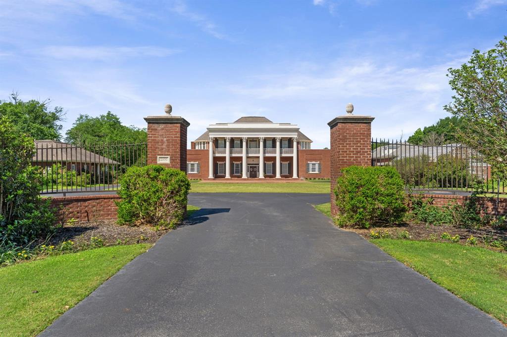 A truly extraordinary Texas estate inspired by history, scale, and legacy living.  2300 Panorama Court is a remarkable replica of The Hermitage — the iconic home of Andrew Jackson in Nashville — masterfully blending timeless Southern grandeur with the privacy and luxury today’s elite buyers demand. Situated on just under 7 acres, and boasting of 8,800 SF property offers unmatched privacy, scale, and versatility in the heart of DFW. The stately main residence features expansive living areas, abundant natural light, and timeless architectural details, ideal for both everyday living and large-scale entertaining. Generous bedrooms, multiple living spaces, and refined finishes throughout create a seamless blend of historic charm and modern comfort. The grounds function as a private compound with multiple structures, including a guest house, greenhouse, and a separate music hall or bonus house—perfect for a studio, office, gym, or additional living quarters. A private lake anchors the property, offering serene views and a rare resort-style setting in Arlington. Mature trees, open green space, and gated privacy provide a secluded retreat just minutes from major highways, dining, and entertainment in the Dallas-Fort Worth metroplex. A rare opportunity to own a landmark estate with acreage, water features, and multiple residences in one of Arlington’s most desirable gated communities.