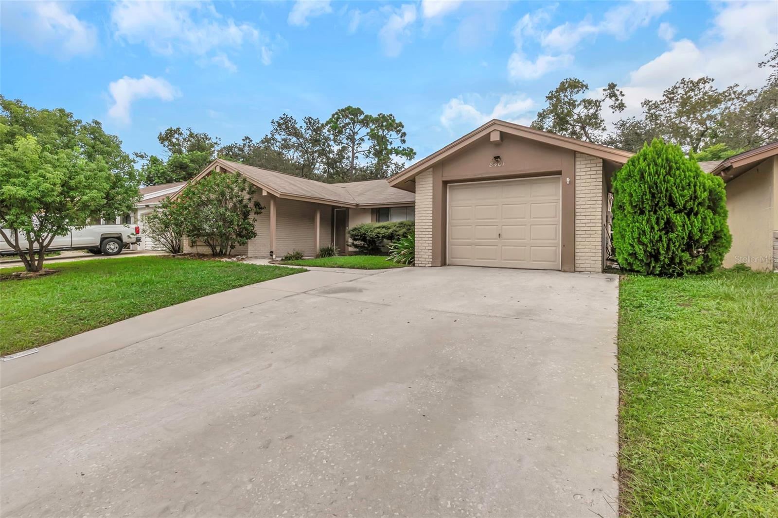 This three-bedroom, two-bathroom home with a one-car garage features a screen-enclosed pool and a spacious covered patio, perfect for entertaining or relaxing outdoors. The kitchen has been updated, and the home offers tile flooring throughout for easy maintenance. A full roof replacement has already been scheduled, and A/C is only a few years old. Located on high and dry ground, this property requires no flood insurance and has not been affected by past storms.