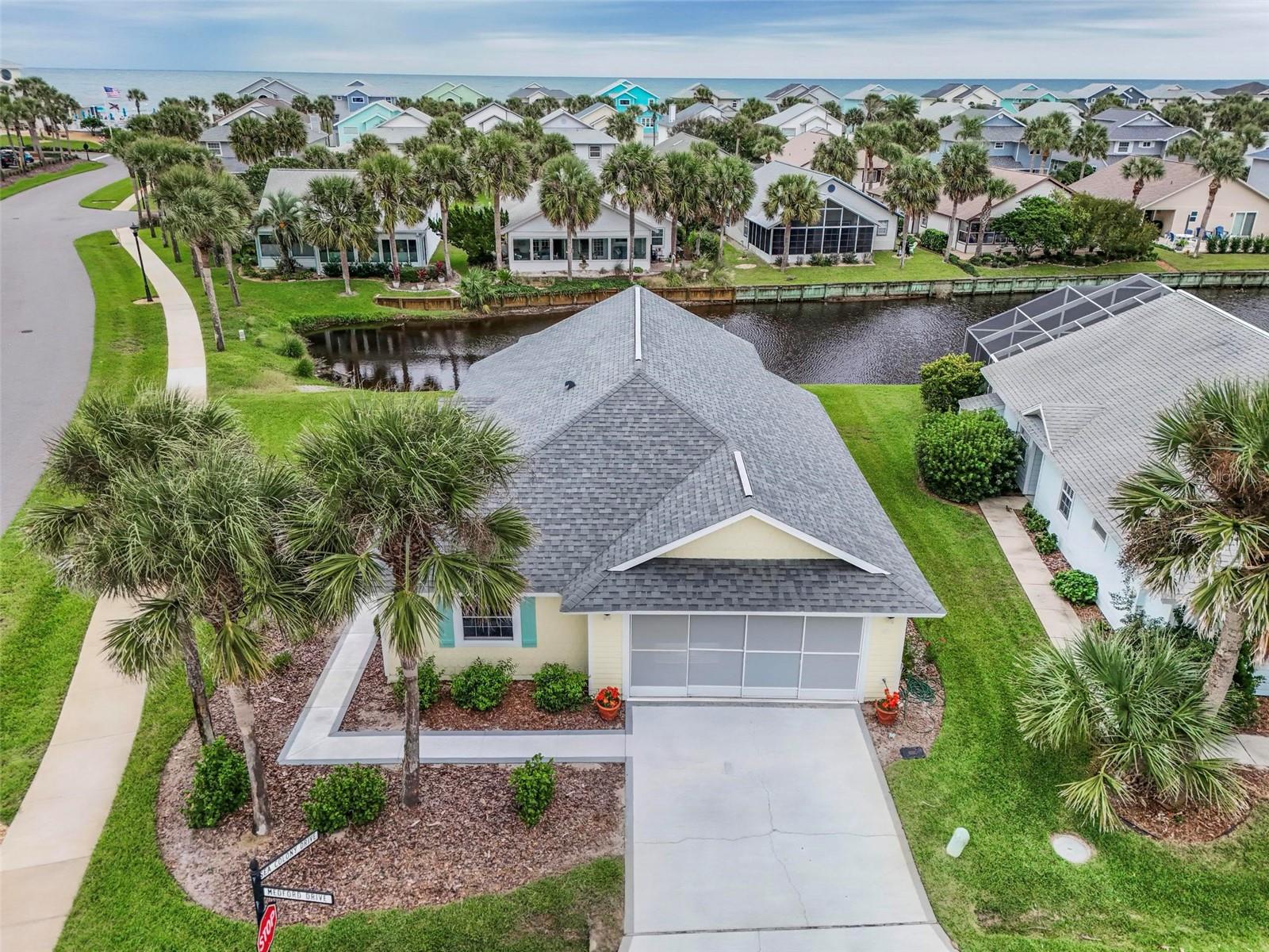 LOCATION! LOCATION! Where can you live steps to the Beach at this price? ALSO awesome view of a lake with a fountain and back to a canal? ALSO steps to the gorgeous clubhouse for many festivities, heated pool and spa. Take your morning coffee to the walkover to watch the sunrise. Walk your fur baby on the beach.  15 minutes to Bings Landing Marina to launch your boat, jet ski, kayak or fish in the Intracoastal waterway. Drive your golf cart to go play tennis and pickleball. 15 minutes to golf courses! 15 minutes to shopping or dining at the local restaurants. 20 minutes to town to medical facilities. doctors and Hospitals. 30 minutes to St. Historic Augustine for dining. 30 minutes south to Daytona Speedway for races and bike week. This home has been family owned for decades and screams pride of ownership. Roof 2018, Electrical panel 2018, Newer H/W heater and has a transferable Termite Bond. What to think about?  So IF you are looking to vacation in this beautiful community that is a hidden secret this is the home for you! GATED COMMUNITY with a guard so very protected. Call to see this beauty today!