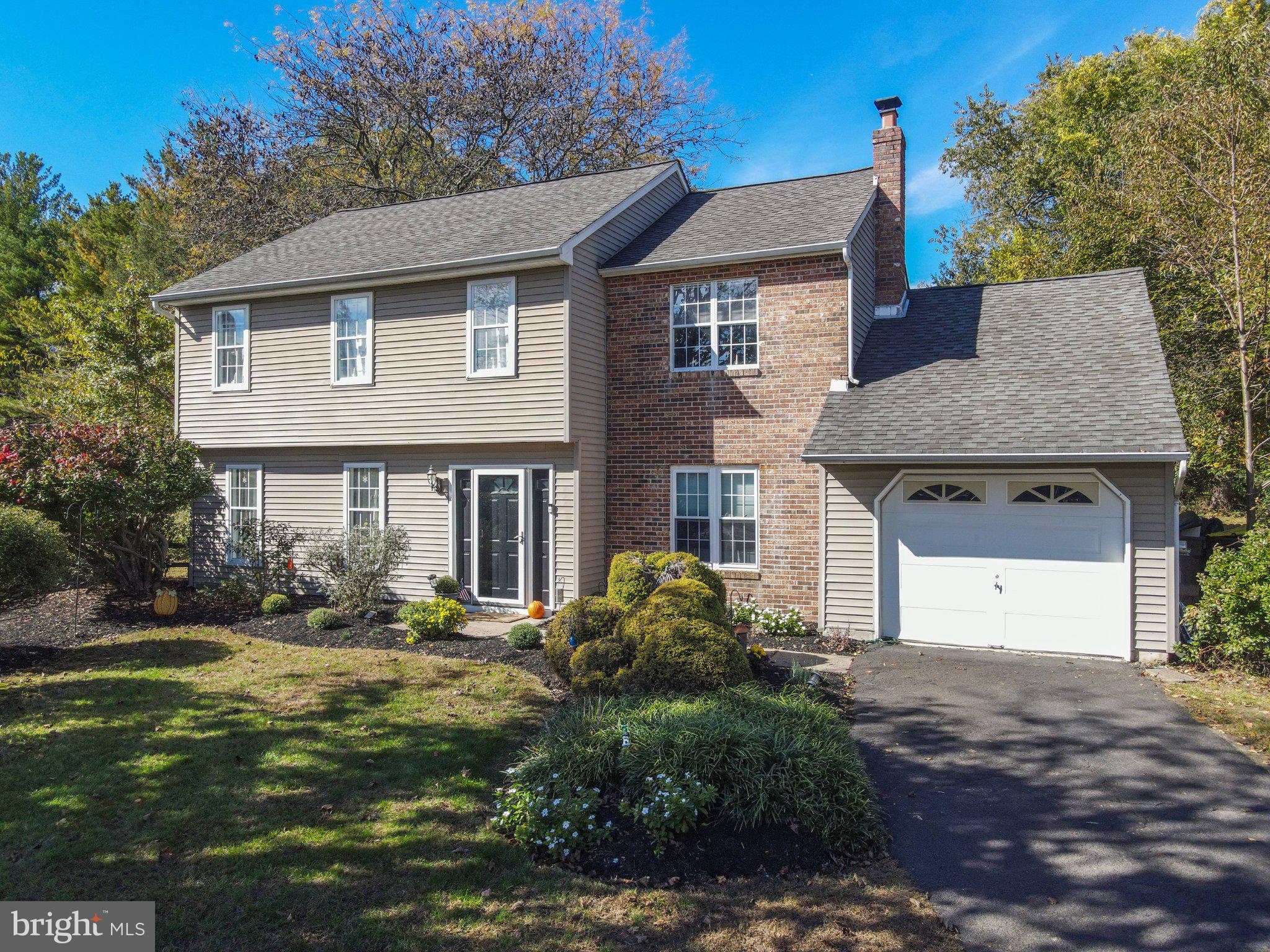 Welcome to The Ridings of Newtown! Nestled on a quiet cul-de-sac in one of Newtown's most desirable neighborhoods, this beautifully maintained 4-bedroom, 2.5-bath Colonial offers the perfect combination of comfort, charm, and convenience. Just a short walk to the shops and restaurants of historic Newtown Borough, this home enjoys a wonderful location with easy access to nearby parks, shopping, and major commuting routes.  Step inside to a welcoming foyer that opens to a bright and sunny living room featuring custom built-in bookcases. Laminate wood flooring flows throughout the main level, complemented by fresh paint in warm, inviting earth tones. The kitchen offers an abundance of wood cabinetry, stainless appliances and plenty of space for everyday meal preparation. Just off the kitchen, the comfortable family room features French doors leading to a private backyard retreat, complete with a patio and mature trees, perfect for outdoor dining, entertaining, or simply relaxing. A convenient powder room, main-level laundry area, and attached one-car garage with inside access complete the first floor. The garage also features pull-down stairs providing access to additional attic storage.  Upstairs, you'll find brand-new neutral carpeting throughout. The spacious primary bedroom offers generous closet space and a beautifull private bath. Three additional nicely sized bedrooms, each with ample closet space, share a full hall bathroom.  The location is hard to beat! Enjoy being within walking distance of the charming shops, restaurants, and local attractions of Newtown Borough, while also being just minutes from Roberts Ridge Park, Core Creek Park, and Tyler State Park. Commuters will appreciate the convenient access to I-95/I-295 and Route 1, making travel to Philadelphia, the Princeton Route 1 Corridor, and nearby train stations with service to New York City a breeze.  With its desirable cul-de-sac setting, private backyard, and exceptional location, this well-cared-for home has so much to offer.