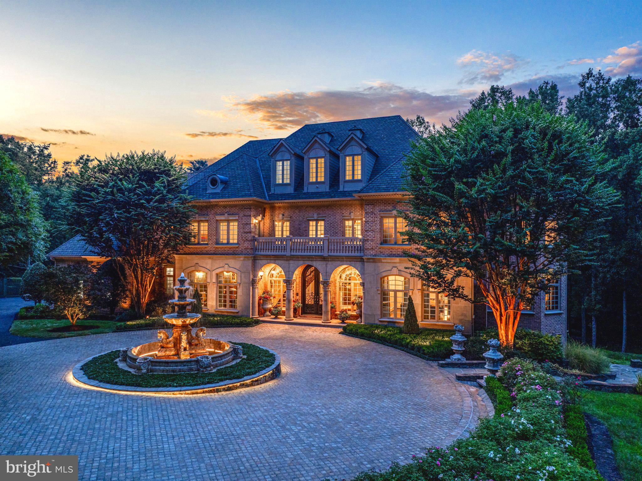 Nestled in the blissful hills surrounding Great Falls Park is a masterpiece of old-world craftsmanship and modern appointments, a unique combination of privacy and accessibility. Walk thru Great Falls Park via your own yard, all the way to the Falls!  Passing through the stately front gates is a breathtaking tree canopied sweeping driveway which culminates at the main residence with its commanding paver circular motor court and majestic fountain. The spectacular fully fenced grounds feature lush specimen plantings, stunning hardscape, antique sculptures, Haddonstone garden gazebo, fountains, thousands of bulbs and so much more! The handsome facade showcases lovely arches and ornate precast columns. Step into the breathtaking foyer where you’re greeted by stunning Swarovski crystal chandeliers in every room, with gleaming marble floors and soaring ceilings setting a tone of timeless grandeur. Stunning plaster moldings with gold appointments and bespoke millwork flow from the foyer seamlessly into the living, dining and great room creating an elegant continuity throughout. The formal living room-bathed in natural light from Palladian windows overlooking the lush grounds exudes warmth and sophistication. French doors open to the music room and conservatory/sunroom, ensuring effortless flow for both grand entertaining and intimate gatherings. The library features lovely hardwood floors with inlay cherry borders, custom built-in cabinetry and custom shutters. A spectacular gourmet kitchen- well-appointed with crystal chandeliers, Viking range, Sub Zero and extra-large kitchen islands with intricate millwork, custom cabinets and countertops, wine/beverage refrigerators, specialty tile backsplash, generous breakfast room with fireplace and floor to ceiling windows and French doors opening to the terrace, brick patio to enjoy morning coffee! Upper level has 5 bedrooms with en-suite full baths. Gleaming hardwood floors, large windows with shutters and backstair case.Primary Suite - is a sanctuary of refinement featuring 23 carat gold leaf ceilings, angled hardwood floors, tray ceilings and a sitting room warmed by a glass-enclosed fireplace all overlooking the stunning grounds. Crystal sconces and detailed plaster moldings accentuate soaring ceilings, blending grandeur with intimacy. Primary Bath- spa-inspired retreat with 20 “marble floors, marble vanities adorned with Mother-of-Pearl inlays and intricate gold inlays and imported Italian tile with custom solid brass fixtures. Indulge in a spa shower with body sprays or unwind in the tub - an indulgent oasis of relaxationThe walk-out lower level crafted for unforgettable gatherings features a billiards area with custom sconces and recessed lighting, a top-of-the-line golf simulator, fireplaces and a state-of-the-art theater with paneled walls and a home gym/work out room. A full kitchen with granite counters and large breakfast bar ensures seamless hosting. A spacious recreation room with expansive windows and a playroom/bedroom with full baths offer versatility. Extra-large 4 car garage. Fenced compound, luscious gardens, terraces, deck, fountains. granite block paver motor court, generators, state-of-the-art security, irrigation system complete this amazing offering. Equestrian in the family? Many facilities in the area! (See map in documents) All within 25 minutes of Dulles & Reagan National airports - Langley High School Pyramid-Registration form needs to be provided with showing request. Thank you!