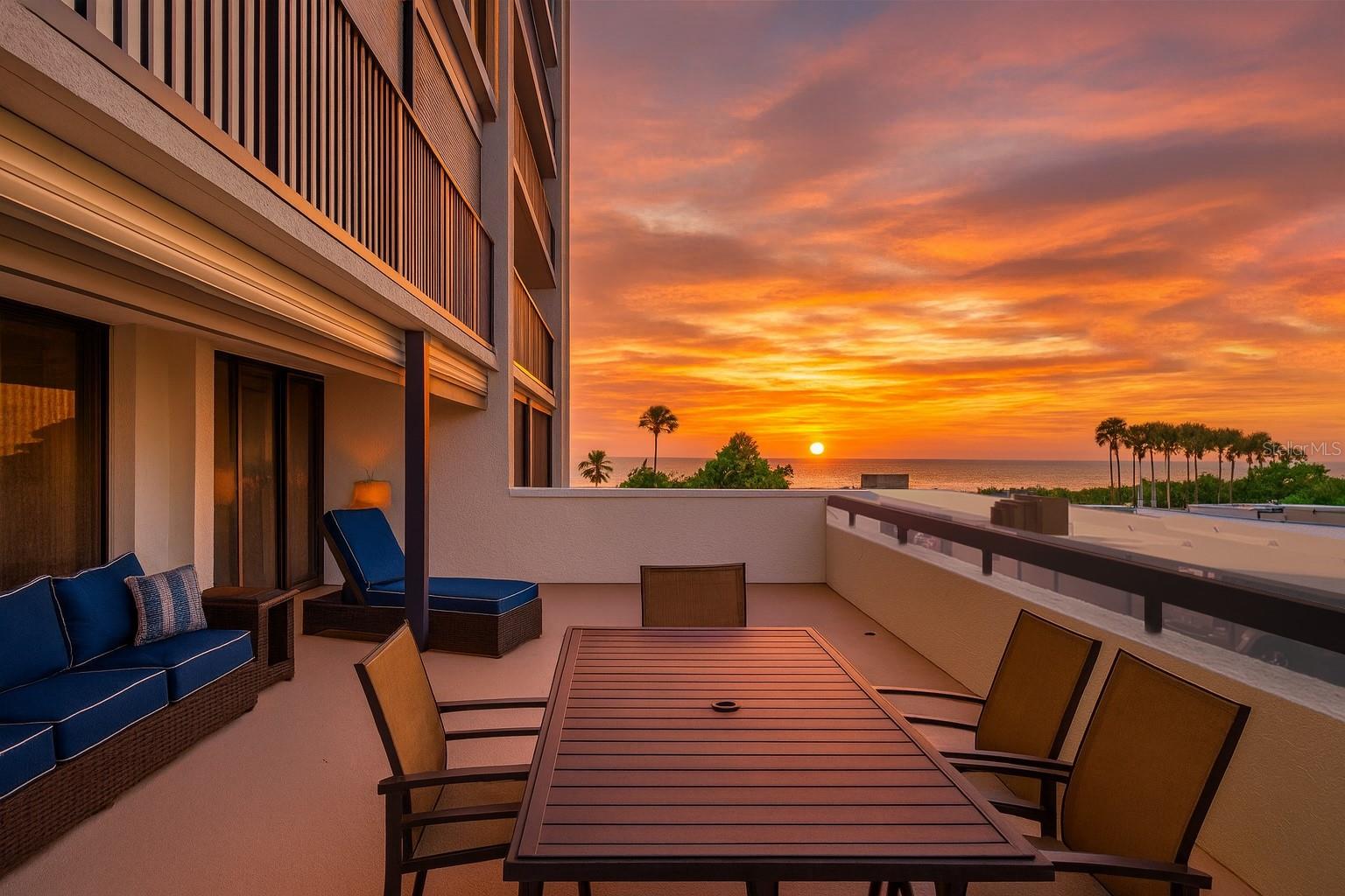 RARE UNIT - 500 sqft OVERSIZED BALCONY! Walk out of your beach residence straight to the pool area, no need for an elevator! This turnkey, fully furnished luxury condo offers an impeccable open floor plan featuring two expansive bedrooms and two exquisitely renovated, spa-inspired bathrooms. Tile flooring flows throughout, enhancing the sophisticated ambiance. The open-concept kitchen and living area seamlessly extend to the oversized patio, where breathtaking views of the Gulf and Intracoastal await. This highly coveted outdoor space is perfect for entertaining or enjoying mesmerizing sunsets. Notable upgrades include hurricane shutters, beautifully textured ceilings, newer AC, water heater, and a washer/dryer. Both bathrooms have been recently remodeled, showcasing modern colors and premium finishes. The master suite is a private retreat, with refined finishes and sliding doors that lead to the patio, blending indoor and outdoor living. Nestled in a prestigious community near the fine dining and boutique shopping of Sand Key, residents enjoy a resort-style pool with ample lounging space, Tiki huts for gathering, and direct access to the pristine white sands of the beach. The building also offers a community room for hosting larger events. This condo includes covered carport parking (#108) and a storage locker (#108). With its prime location, you are a short walk from the vibrant Shoppes of Sand Key and renowned restaurants like Columbia and Backwaters. The trolley, pickup spot for which is conveniently located just outside the community, offers easy access to Clearwater’s abundant dining, shopping, and entertainment options. Tampa International Airport is a short 20-minute drive, and Tampa and St. Petersburg are close by for endless adventures.