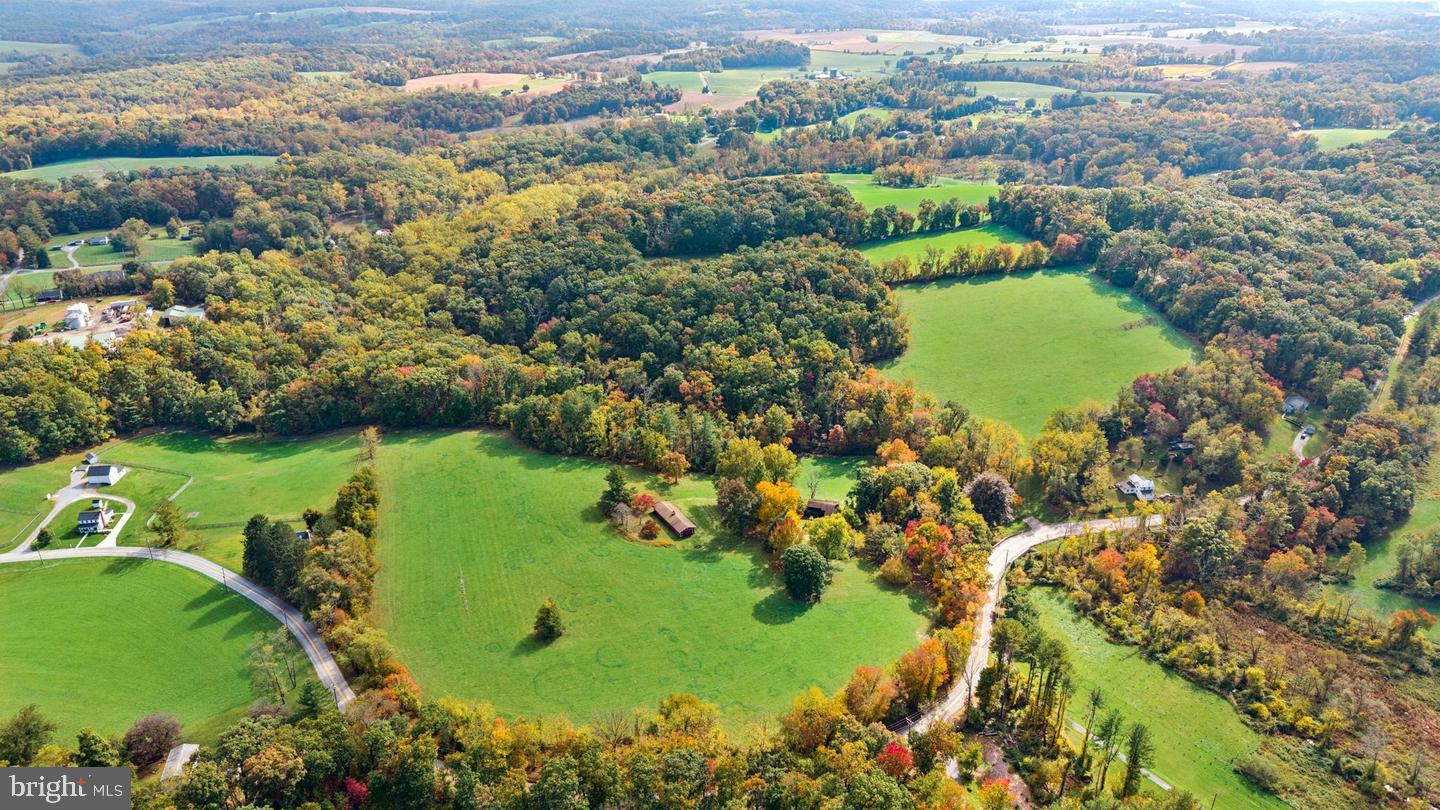 A rare opportunity to own 43+ preserved acres of pasture, woodland, and stream frontage in a prime Baltimore County location. This private farm offers 23 acres of agricultural land, 20 acres of woodlands, and approximately 1,020 feet of Little Piney Run, a setting for riding, hunting, hiking, farming, or simply enjoying the quiet countryside. The property is protected by a conservation easement that encompasses three parcels, which remain together as one. The 1973 split-foyer home, with approximately 1,500 square feet and an attached two-car garage, is in poor condition and not habitable in its current state. It’s ready for a new owner to renovate, modernize, reimagine, and make it their own. The home site is established, providing a terrific opportunity to improve or expand the existing residence efficiently and economically. The conservation easement allows one single-family detached home of up to 8,000 square feet, giving you a generous canvas to expand the existing residence or, with approval, to reimagine the home site. A well-maintained barn provides an immediate head start for horses, livestock, equipment, or hobby farming. For the equestrian, outdoorsman, farmer, or buyer seeking a legacy property in a protected landscape, this is an uncommon opportunity to secure acreage in a coveted area and build the home and lifestyle you envision. Please see the document tab for conservation easement details. Estate sale, sold AS IS.