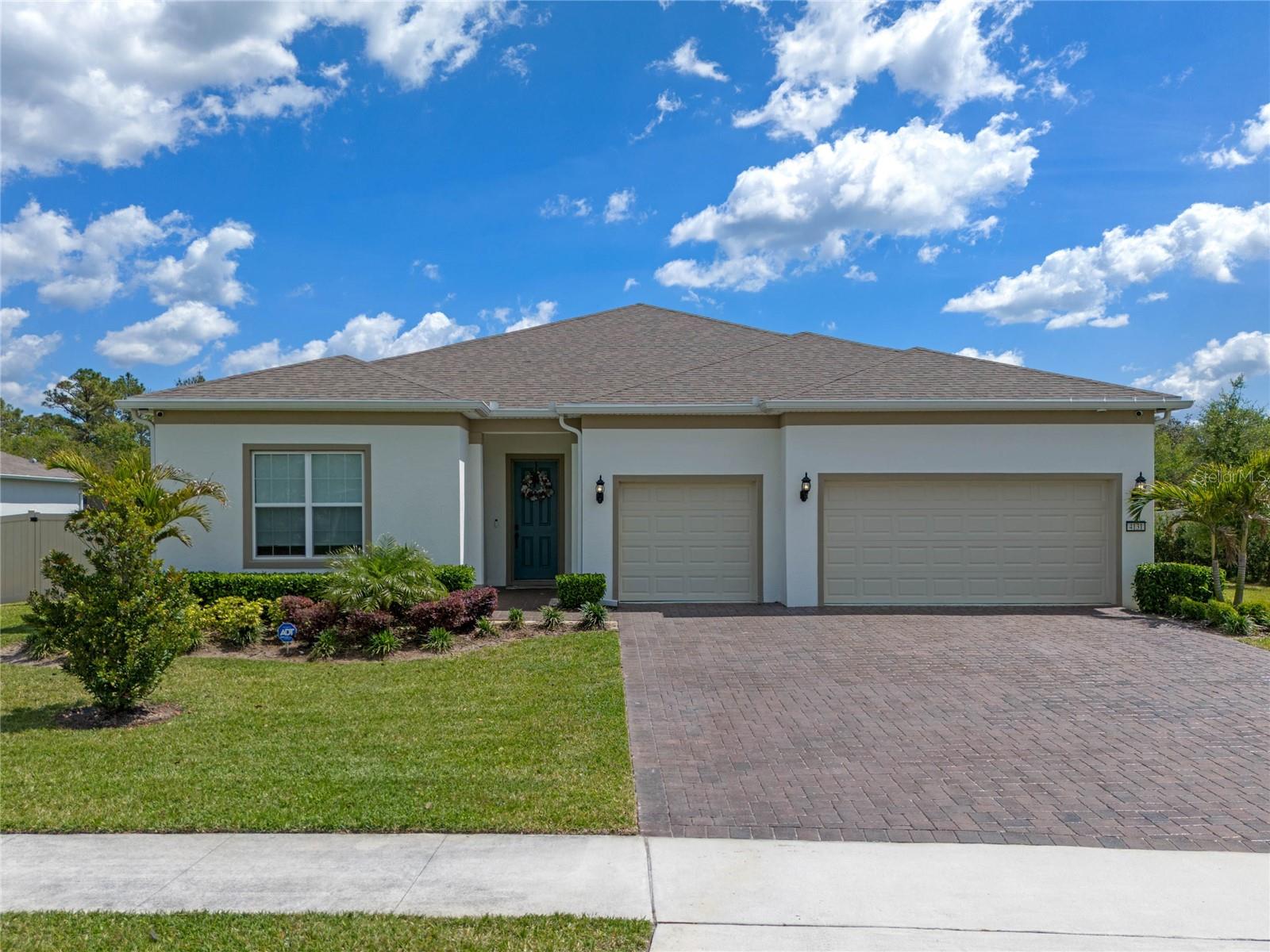 Welcome to this stunning, nearly-new 3-bedroom, 3.5-bath home, located in a highly desirable, gated community. At just 2 years old, this home offers the perfect combination of modern luxury and energy efficiency, featuring solar panels that help reduce your carbon footprint and energy costs. Nestled on a spacious 1/2 acre fenced lot, you'll enjoy privacy and plenty of room for outdoor activities. The property has a well for irrigation. Step inside and be greeted by a chef's kitchen equipped with elegant quartz countertops imported from Spain, built-in stainless steel appliances, and ample storage space—ideal for preparing gourmet meals. The luxury vinyl flooring and procelain tile throughout adds both beauty and durability to the home.The primary bedroom is a true retreat, complete with double walk-in closets, offering generous space for your wardrobe and accessories. The primary suite has a spa-like ensuite bath, complete with a soaking tub, frameless shower, and brand new herringbone tile floors. Each of the three bathrooms is thoughtfully designed with modern finishes, ensuring comfort and style throughout. All bedrooms feature a private bath and walk-in closets. The home features luxury shades throughout with motorized blackout shades in the primary suite. Built-in surround sound ceiling speakers in the living room.  A dedicated office space provides a quiet place to work, and the 3-car garage offers plenty of room for your vehicles and additional storage needs. Best of all, this home offers a front-row seat to rocket launches from your own backyard! Imagine enjoying breathtaking views of one of the most exciting spectacles, right from your own private oasis. The neighborhood has access to Lake Pickett, including a community boat ramp and dock. This exceptional home blends comfort, convenience, and modern amenities in a prime location—schedule your tour today!