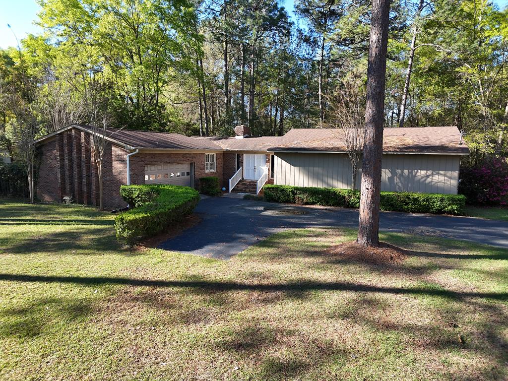 Located on the desirable south side of Thomasville, this charming 3-bedroom, 2-bath home sits in a popular, family-friendly neighborhood just 40 miles from Tallahassee. The home features beautiful custom oak floors throughout and a welcoming double front door that opens into a warm, inviting interior. The spacious den and dining room are highlighted by multiple French doors, filling the home with natural light and offering seamless access to the outdoor living space. Step outside to enjoy a private brick patio complete with a fireplace—perfect for entertaining or relaxing year-round. A private school is conveniently located nearby, adding to the appeal of this well-established neighborhood. With classic details, thoughtful design, and an ideal location, this home offers comfort, character, and convenience.