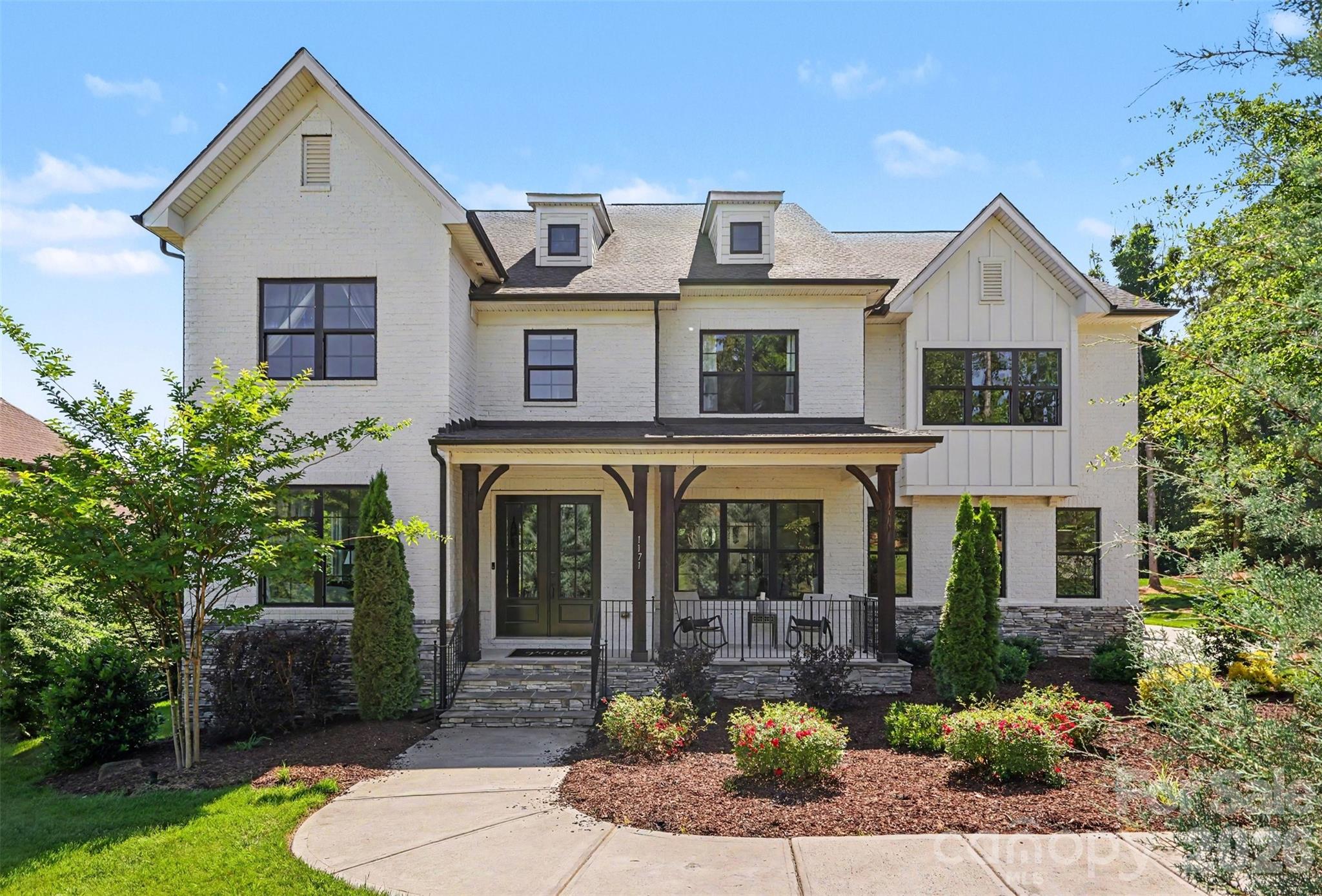 Welcome to this truly exceptional full-brick custom estate, perfectly situated on a beautifully landscaped one-acre homesite in the highly sought-after, award-winning Fort Mill School District. Offering the ideal balance of luxury, privacy, and thoughtful design, this remarkable home showcases upscale finishes, expansive living spaces, and resort-style outdoor amenities designed for both everyday living and unforgettable entertaining.From the moment you enter, you're greeted by an impressive foyer, elegant staircase, and abundant natural light that fills the home. The thoughtfully designed main level features a dedicated home office, formal living room, spacious dining room accented with craftsman-style molding, powder room, and a private in-law suite with a full bath—ideal for visitors or multigenerational living.At the heart of the home is the stunning two-story great room, highlighted by cedar box beam detailing, a 48-inch linear fireplace with blower and remote, and a dramatic 16-foot bi-parting sliding glass door that seamlessly connects indoor and outdoor living spaces.The chef's kitchen was designed to impress, featuring premium GE Monogram appliances including a 48-inch built-in refrigerator, 36-inch dual-fuel range, wall oven, custom Kith Homestead maple cabinetry, an oversized center island, walk-in pantry with custom shelving, and a butler's pantry complete with wine cooler.Upstairs, the luxurious owner's retreat offers a private sanctuary with a vaulted ceiling, cedar beam accents, motorized shades, dual custom-designed walk-in closets, and a spa-inspired bath featuring a freestanding soaking tub, oversized tiled shower, separate vanities, and additional motorized shades for privacy and convenience.Generously sized secondary bedrooms provide large closets and ample space for family and guests. A dedicated media room—with projector included—and adjoining half bath create the perfect setting for movie nights, game days, or entertaining.Step outside and discover a backyard retreat designed for year-round enjoyment. The custom outdoor kitchen features premium Coyote appliances and is complemented by an expansive travertine paver patio, Trex decking with cable railing, and a covered porch equipped with motorized screens and a motorized pergola system—creating the ultimate indoor-outdoor lifestyle experience. Septic placement thoughtfully designed to accommodate a future pool installationThe property extends well beyond the firepit into the wooded area, creating a private setting reminiscent of neighboring estate lots while still offering usable outdoor space for recreation and relaxation.Located just minutes from shopping, dining, and everyday conveniences—with a new grocery store opening nearby—this extraordinary property offers a rare opportunity to enjoy luxury living, exceptional craftsmanship, and one of the most desirable locations in Fort Mill.
