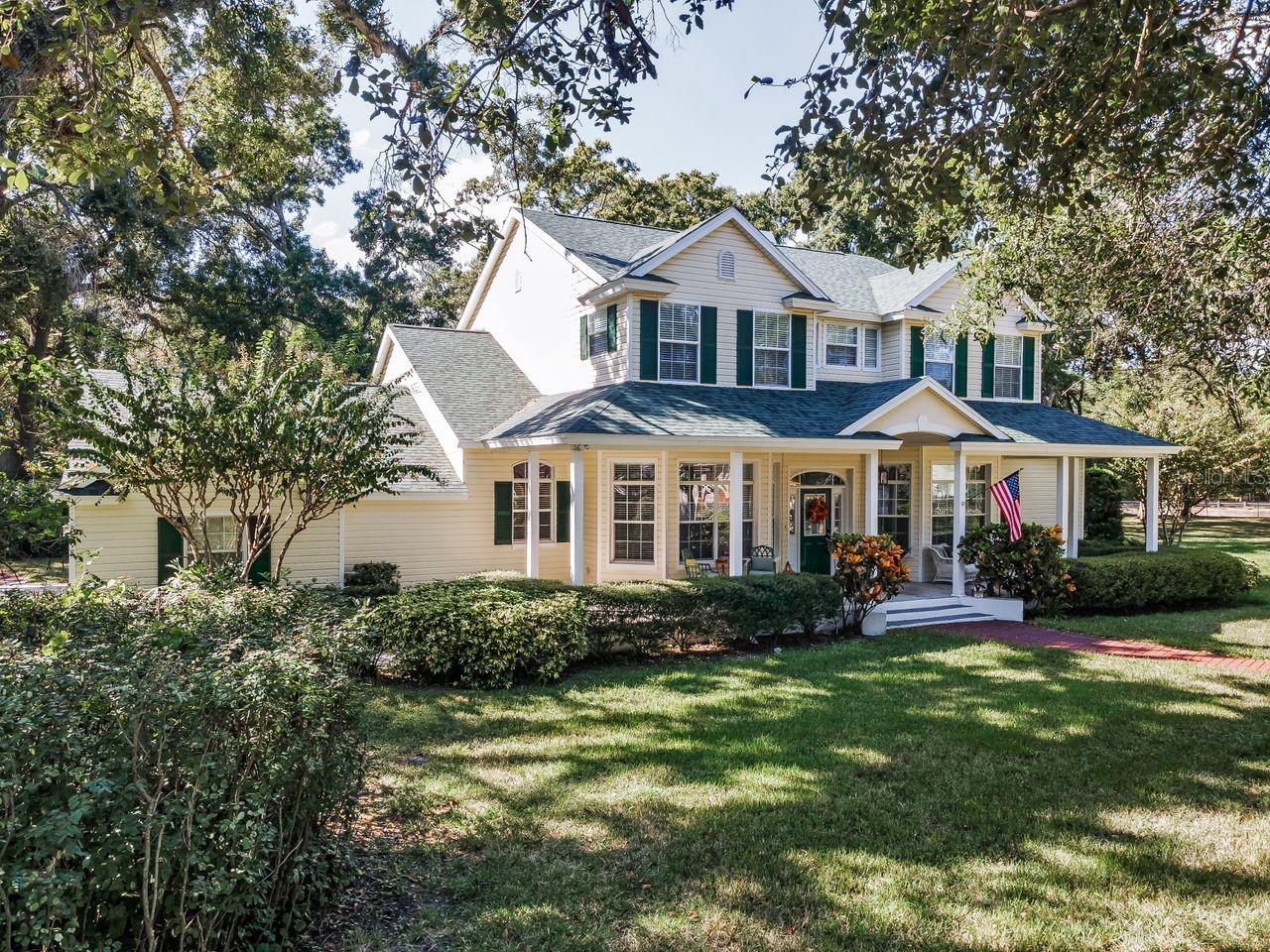 Nestled in the heart of Pinellas Park's equestrian community, this stunning home sits on 3 acres, offers 4 bedrooms, 2.5 bathrooms, with ample living space and numerous amenities. The generously sized primary suite features an impressive double-sided stone fireplace that connects to the living room. The primary suite includes an adjacent bedroom which would work well as a home office, home gym, or potential nursery. The home boasts a large loft area, perfect for a home office, hobby room, or additional living space. The 2 upstairs bedrooms share a Jack & Jill bathroom, providing convenient access and privacy. A bonus room offers additional storage space.

The kitchen features window seats that offer even more storage space. The living room showcases custom built-in shelving, adding both style and functionality. The home is equipped with double-pane windows, an HVAC system that is 3 years old, and a roof that is 2 months old, ensuring energy efficiency and comfort.

The covered front and rear porches invite you to relax and enjoy the outdoor environment. The 3-car garage provides ample storage and parking. The gated property is completely fenced, with a large outdoor firepit and covered RV parking that includes a 50-amp hookup. A detached garage, with 3 electric roll-up doors, provides additional storage and workspace options. The small shed near the rear garage is climate-controlled, making it suitable for use as a kennel or chicken coop, complete with its own fenced area.

The property is zoned for horses, close to riding trails, and has potential for expansion with zoning for a guest home. The long circular driveway provides ample parking and easy access to the home. Don't miss out on the opportunity to makes this stunning home yours!