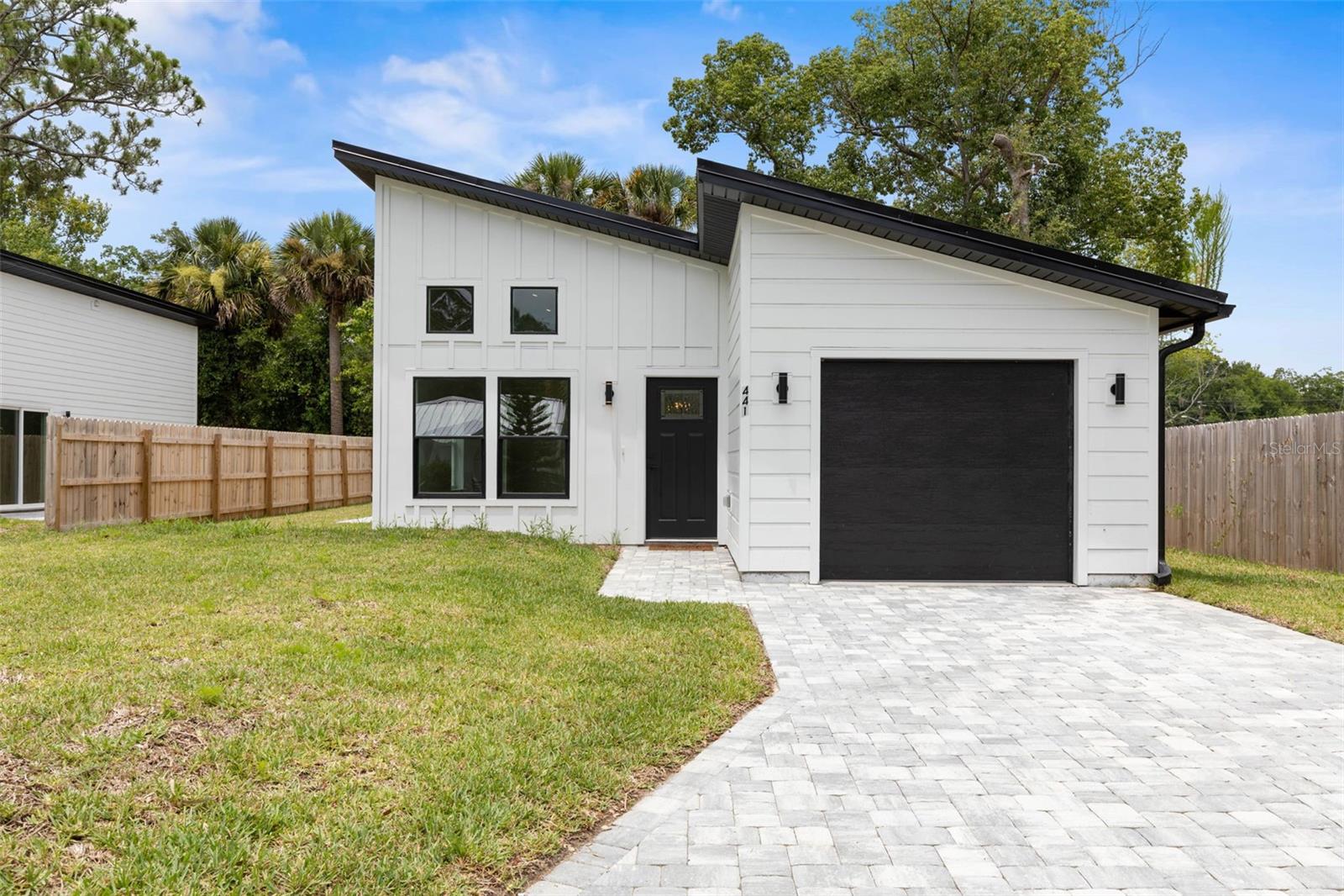 One or more photo(s) has been virtually staged. Introducing 441 S Woodlawn St. A beautifully crafted new construction home (2024) nestled in the established Colee Subdivision of St. Augustine. This thoughtfully designed 3-bedroom, 3-bathroom residence features 1,180 square feet of modern living space, complete with stylish upgrades.
Inside, you'll find an open concept layout with soaring vaulted ceilings and wood-look vinyl flooring throughout, creating a light and airy atmosphere. The sleek kitchen features quartz countertops, stainless steel appliances, and clean, modern finishes—perfect for both everyday living and entertaining. Sliding glass doors lead out to a paver patio and a  fenced backyard, ideal for outdoor relaxation or play.
The primary suite offers a private retreat with a walk-in closet, step-in shower, and contemporary touches. The second bedroom features its own en-suite bathroom, making it perfect for guests or family members. The third bedroom can easily serve as an office, playroom, or flex space, depending on your needs.
Located just minutes from historic downtown St. Augustine, top-rated St. Johns County schools, parks, and local restaurants, this home provides the perfect combination of quiet neighborhood living with convenient access to everything the area has to offer.
Don’t miss this opportunity to own a brand-new home in one of St. Augustine’s most charming and well-located communities—schedule your showing today!