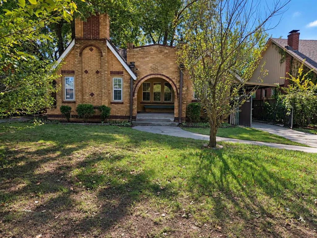 Full of character and modern touches, this beautiful brick home offers comfortable living with plenty of space to enjoy! The living room features wood flooring, a fireplace, and large windows that bring in natural light. The kitchen includes granite countertops, dark wood cabinetry, stainless steel appliances, and a convenient breakfast bar. Spacious bedrooms, stylish bathrooms, and a versatile upstairs bonus area provide flexibility for a home office, game room, or additional living space. A separate laundry area with washer and dryer adds convenience. Outside, enjoy a spacious backyard shaded by mature trees, a storage shed, and covered parking. The classic brick exterior and arched front entry give this home its distinctive curb appeal. Schedule your showing today!
