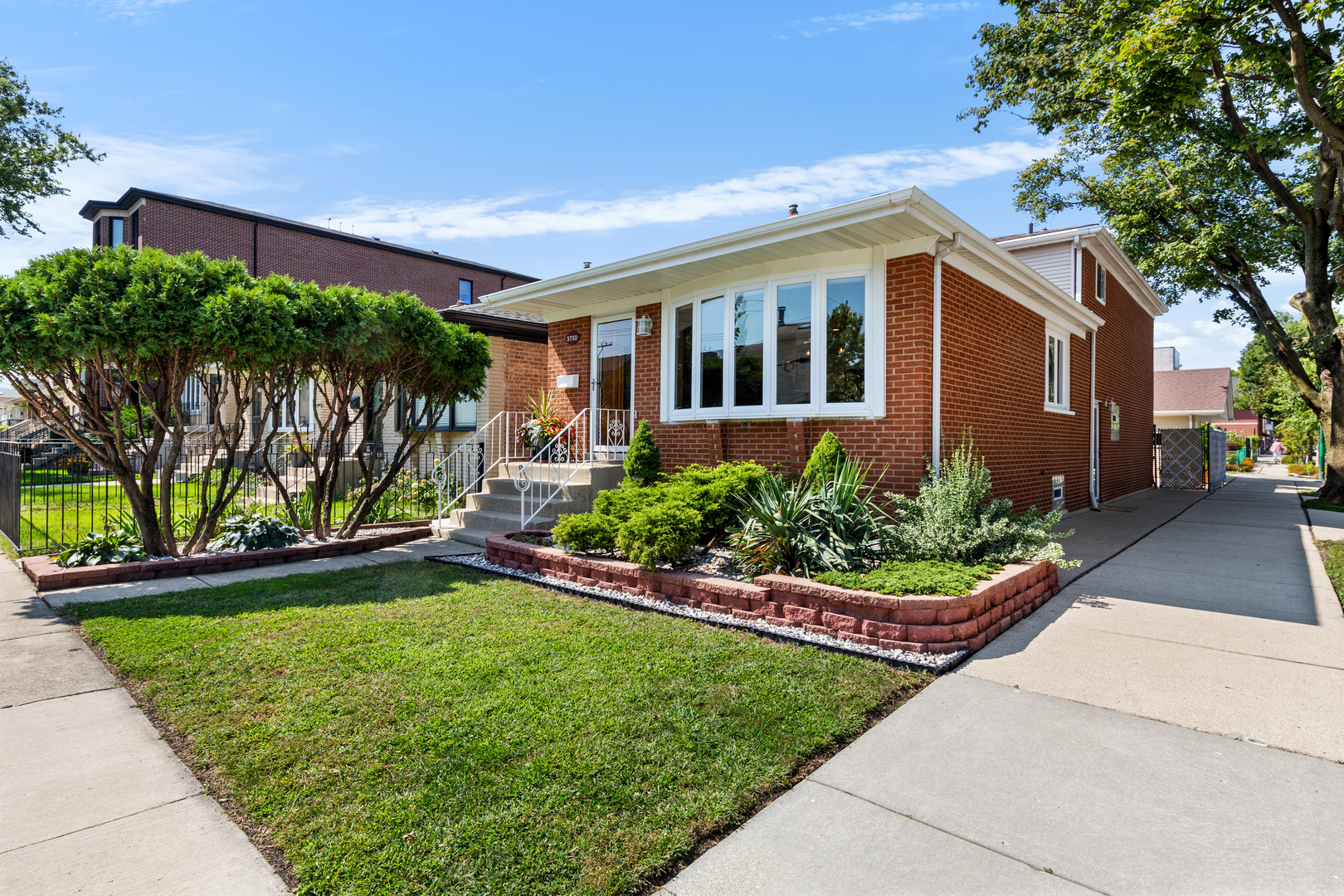 Beautiful Corner Lot | Solid Brick Tri-Level Home in Bridgeport --  4 Beds | 2 Baths | 3 Finished Levels | Built 1972 -- Fall in love with this meticulously maintained, move-in ready brick tri-level located on a beautiful tree-lined street in the heart of Bridgeport! Nestled on a spacious corner lot, this home combines timeless charm with modern updates and thoughtful design throughout. Step inside to find a bright, open-concept main level with a side-entry layout that maximizes space and natural light. The sun-filled living room boasts a large bay window, gleaming hardwood floors, and recessed lighting, creating the perfect setting for relaxing or entertaining. The updated eat-in kitchen is a chef's dream, featuring extra-thick granite countertops, white cabinetry with roll-out drawers, a double sink, a warm designer backsplash, and stainless steel appliances. Don't forget there is a bedroom on the main floor as well.  Just a few steps down, enjoy an additional living room with double oak patio doors leading to your private outdoor oasis - perfect for summer barbecues or quiet evenings under the stars. Downstairs, the fully finished basement offers endless possibilities with a bar (can remain or be removed), a large laundry area with extra refrigerator, utility sink, and workout space, and a lifetime waterproofing warranty from U.S. Waterproofing for total peace of mind (2024) and Aprilaire Humidifier (2024). Both bathrooms are beautifully updated and customized, featuring a luxurious garden tub and a separate walk-in shower. Upstairs, you'll find three spacious bedrooms with hardwood floors, tall ceilings, and generous closets - plenty of room for family, guests, or a home office. Additional Highlights: 2.1-car brick dormer garage with party door & extra storage, Roof (2020), Furnace & A/C (2022), All walls replaced & insulated, Newer windows with custom oak trim throughout, Simply Safe wireless security system included. This is more than just a house - it's a move-in ready home thoughtfully cared for inside and out. Don't miss your chance to own this Bridgeport gem!  Walking distance to Sox Park.