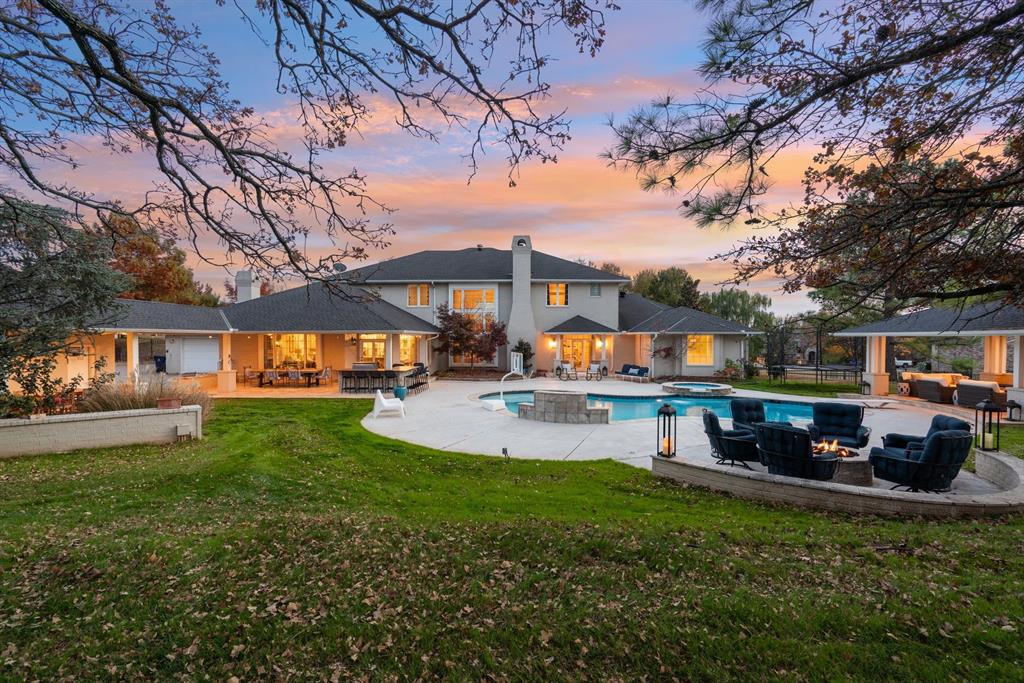 Gorgeous golf course home located in peaceful River Oaks in sought after Oakdale Schools! This stunning residence sits on a beautiful 1-acre lot overlooking the 18th hole of River Oaks Golf Club. Nestled on a private gated block within the community, offering exceptional comfort, thoughtful updates, and expansive living spaces. Enjoy multiple outdoor living areas including a covered gazebo with fireplace, firepit lounge, outdoor kitchen on the covered patio, and a sparkling pool with spa, water feature, and tanning ledge, plus a convenient cabana bath for guests. Inside, the home feels warm and inviting with a well-designed layout. The main level features a formal living area, dedicated study, and a cozy TV room off the kitchen with additional dining space and a wet bar. Large windows flood the home with natural light and showcase breathtaking golf course views. The luxurious primary suite is located on the first floor and includes a fireplace, private backyard access, spacious closet, spa-style bath, and an attached home gym. A secondary guest suite with its own en-suite bath is also located downstairs. Upstairs are three spacious bedrooms, two connected by a recently remodeled Jack-and-Jill bath, each with private vanities and walk-in closets. An additional upstairs room offers flexibility for an optional bedroom, media room, or playroom. Access the second level via the grand front staircase or a convenient back staircase near the laundry room. With 4-car garage space, circle drive, and abundant extra parking, this home is designed for both convenience and entertaining. The entire home has been updated with modern finishes and designer touches. A Geothermal system powering the utilities add provides energy efficiency. A rare opportunity on a full acre in highly desirable Oakdale School District!