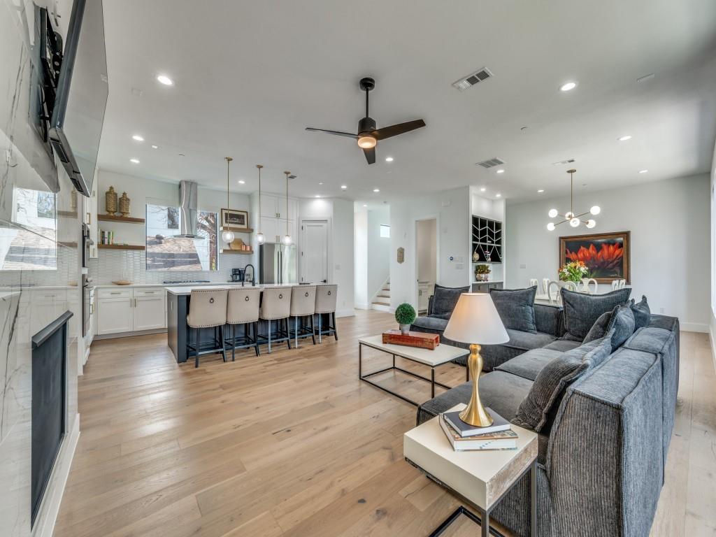 One of the most desirable floor plans in the neighborhood, this unique complex stands out for its spacious room sizes, abundant natural light, and exceptional outdoor living. Expansive windows brighten the home, while a custom pergola creates an inviting extension of the living space outdoors.The second level features an open-concept design ideal for both everyday living and entertaining, complete with a fireplace, a dedicated dining area with built-ins, and a well-appointed kitchen. The primary suite offers a generous layout and a private ensuite bath. On the third floor, a secondary bedroom, built-in hallway shelving, and a full laundry room provide comfort and convenience.  The first floor bedroom also provides an ensuite bath. The turfed backyard provides a low-maintenance setting perfect for relaxing or hosting guests. Ideally located with easy access to major freeways, SMU, Baylor, Uptown, and the popular restaurants and shops along Greenville Avenue, this home combines style, function, and an exceptional Dallas location.