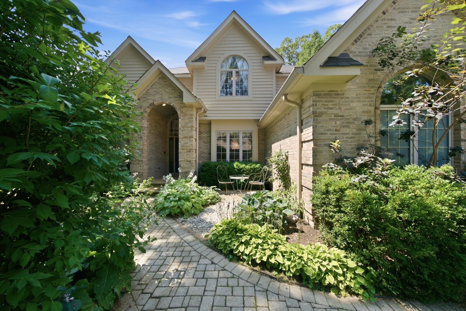 Stately curb appeal, a kitchen built for real life, and room for everyone. This one has it all.    The professionally landscaped lot and classic exterior make a strong first impression. Inside, the dramatic entry opens to soaring ceilings, rich hardwood floors, and crown molding. The spaces feel elegant without being stuffy.    The chef's kitchen is the heart of the home. It has a Viking range, crisp white cabinetry with warm gold hardware, an oversized island, and a dedicated coffee bar. Holiday crowds and quiet Tuesday mornings both work well here.    Every room has a purpose. Curl up by the fireplace, host dinner in the formal dining room, or read in the library. The sun-filled sunroom overlooks the backyard, and outside, a large paver patio framed by mature trees gives you a private spot to entertain or unwind.    The primary suite is your retreat. Its spa-style bath has heated floors, a large walk-in shower, and a soaking tub. The secondary bedrooms are generous. The finished basement adds another bedroom, built-ins, and plenty of storage, so it works for guests, a rec room, or multi-generational living.    The three-car garage has room for vehicles, toys, and hobbies. You'll have privacy and space at home with easy access to Metra and the expressway. Weekends are covered too, with the Chain O' Lakes, nearby forest preserves, Gurnee Mills, and Great America all close by.    Updated, meticulously maintained, and move-in ready. Come see it in person.
