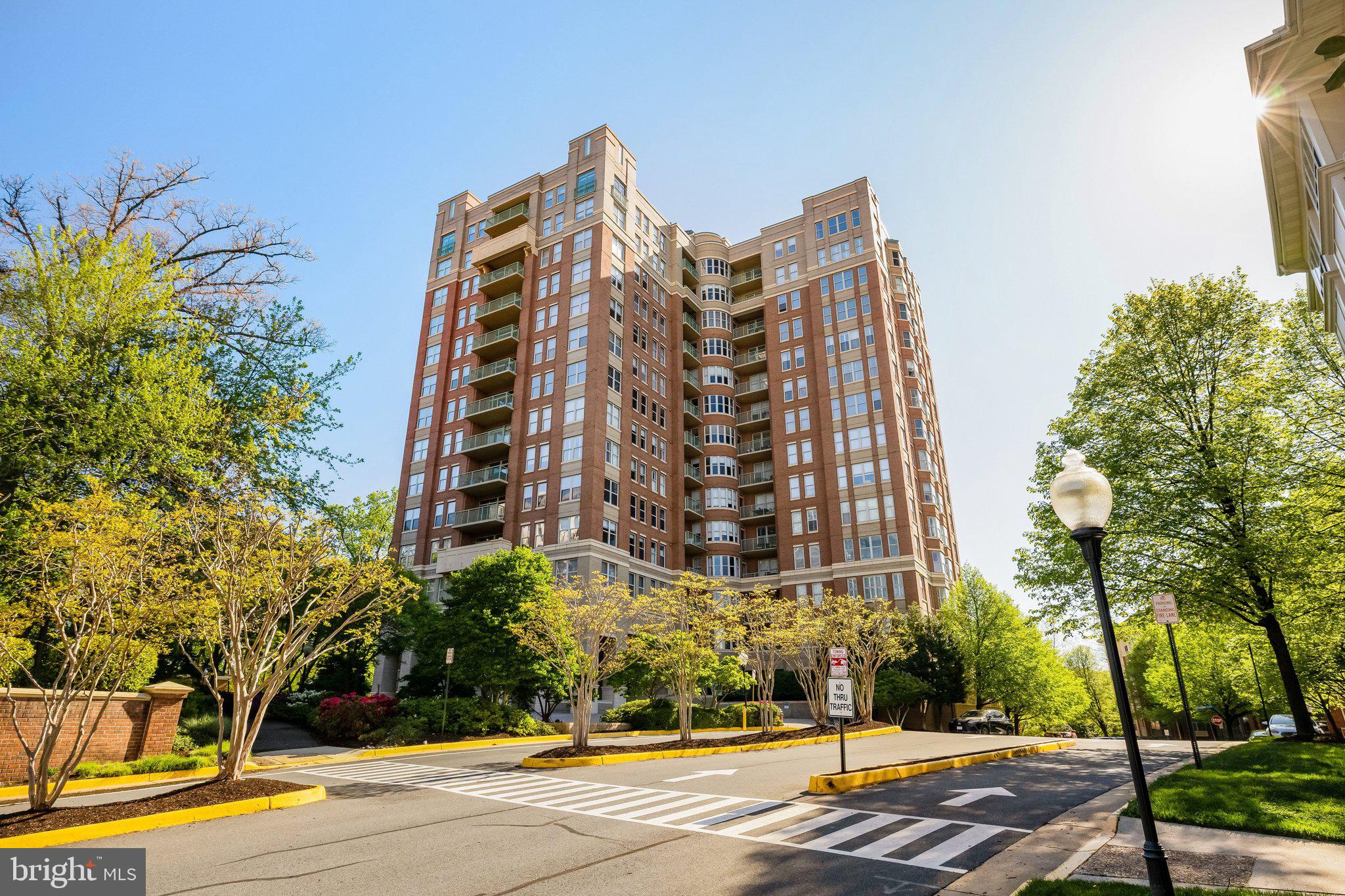 Experience luxury penthouse living in the heart of Reston! This exceptional 3 bedroom, 3 full bath residence on the top floor of Stratford House offers close to 2,100 square feet of beautifully designed living space, with 9 ft. ceilings, abundant natural light, and breathtaking panoramic eastern views — on a clear day, you can see 15 to 20 miles across Reston’s bucolic, wooded landscape.From the moment you arrive, you’ll be welcomed by the building’s luxurious lobby and concierge service, offering convenience, security, and an elevated lifestyle. A standout feature of this residence is its enclosed balcony/sunroom — an optional upgrade rarely found in the building — creating a versatile, climate-controlled space perfect for relaxing, entertaining, or simply enjoying the scenery year-round.The elegant living room features a gas fireplace creating a warm and inviting focal point while showcasing those spectacular views. The gourmet kitchen is appointed with granite countertops, stainless steel appliances, and abundant custom cabinetry, seamlessly connecting to the open living and dining areas.The impressive primary suite serves as a private retreat, complete with two walk-in closets, a separate shoe closet, and a spa-inspired bathroom featuring double vanities, a jetted soaking tub, and a separate glass-enclosed shower. A second bedroom with its own full bath offers comfortable accommodation for guests or family, while a third bedroom provides flexible space ideal for a home office, study, or additional guest room. Hardwood floors, recessed lighting, and custom window treatments.This penthouse includes 2 underground parking spaces and a private storage unit, plus ample guest parking.Ideally situated across from Reston Town Center and just moments from the Silver Line Metro, Dulles International Airport, and major commuter routes, this home offers unparalleled access to premier shopping, dining, entertainment, and travel — plus nearby parks, lakes, and miles of walking, jogging, and biking trails. Residents also enjoy resort-style amenities including a swimming pool, fitness center, business center, library, and social room.Enjoy maintenance-free luxury living without sacrificing space, comfort, or style — a rare opportunity to own one of Reston’s most desirable penthouse residence you won’t easily find elsewhere in the building.