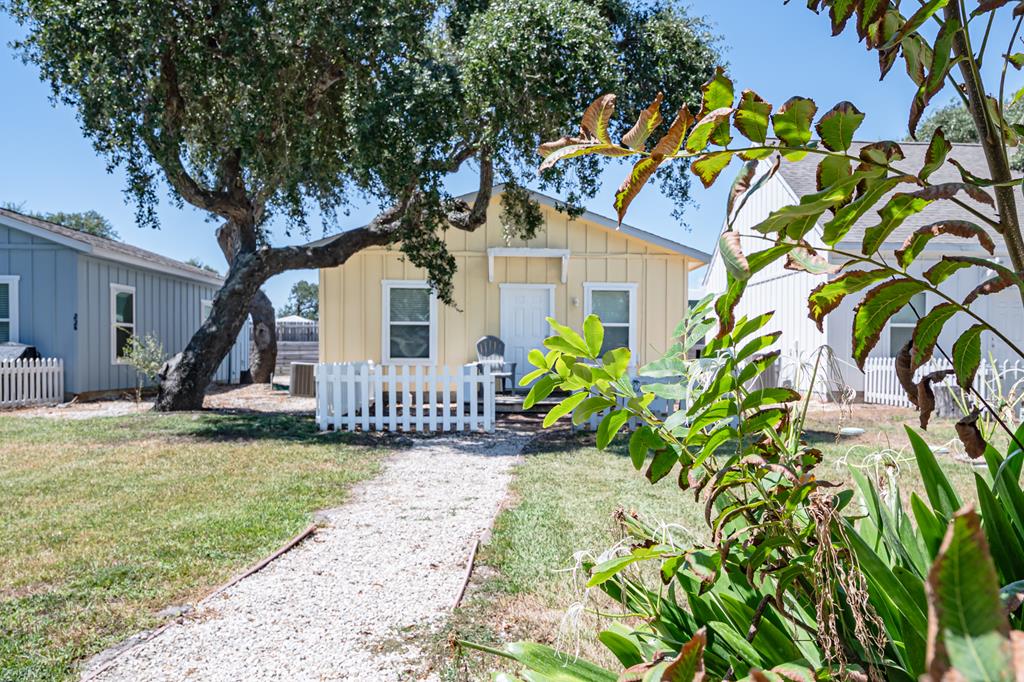 Coastal Cottage Escape – Turnkey & Investment-Ready! This charming 2-bedroom, 2-bath coastal cottage is priced just right to get you away from it all—or start generating income immediately! Located in a boutique stand-alone subdivision on the south side of Rockport, TX, you're just minutes from Cove Harbor Marina & boat ramp, downtown shopping, dining, and the Blue Wave Beach.  Designed for comfort and efficiency, the open-concept kitchen offers attractive butcher block countertops and plenty of space to prepare your coastal favorites. The primary bedroom features an ensuite bathroom, while the second bedroom has a full bath just steps away—perfect for guests.  Enjoy your own private front yard, while the community amenities offer a sparkling pool, fire pit, and beautiful ancient oaks that set the scene for relaxation. Low monthly HOA fees include water, sewer, garbage, lawn care, pool service, and common area upkeep—allowing you to show up, enjoy, and leave without a worry or hand the keys to guests with confidence.  Whether you're seeking a personal coastal getaway, a short-term rental investment, or both, this property checks all the boxes. Fully turnkey and ready to enjoy or rent from day one!