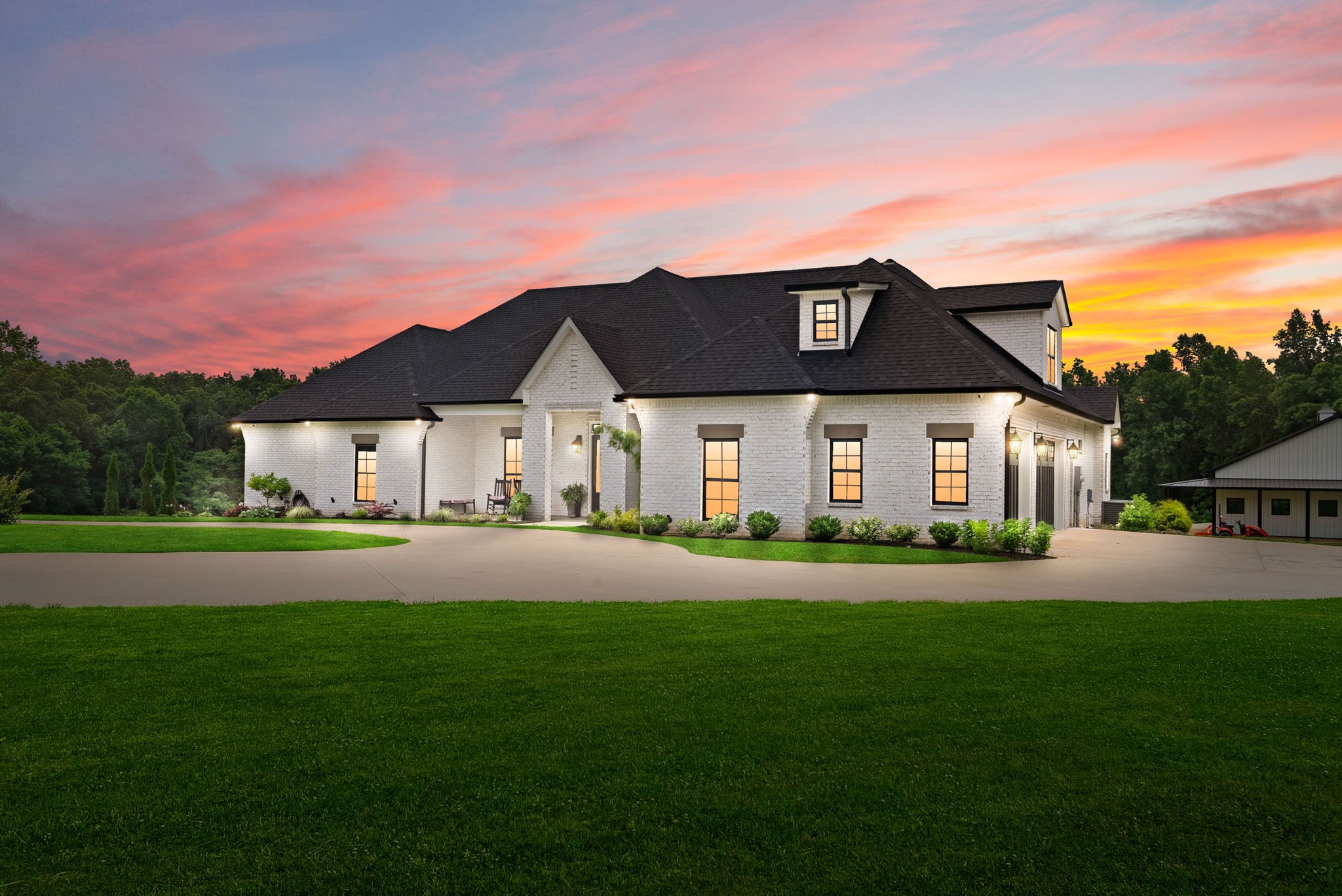 Stunning custom ranch home on 12 private acres- NO CITY TAXES or Neighbors. Spacious open concept layout with tall ceilings, rich trim, no carpet and designer touches throughout. Chef's kitchen features Cafe Collection appliances, gas cooktop. pot filler, warming drawer, hidden pantry, quartz countertops, and a wet bar with a touchless sink. Split bedroom floor plan offers privacy with a luxurious primary suite featuring a cathedral ceiling with white beams, heated marble flooring, freestanding tub, dual vanities, dual closets, and an impressions make up vanity. On the other side of the house you'll find two guest bedrooms with a jack and jill bathroom. The third guest room has an ensuite. All bedrooms have massive walk in closets with custom shelving. Quartz countertops and mosaic tiling throughout. The formal dining room has a detailed ceiling, grass cloth wall paper and wainscoting. The den offers separate living space with a coffered ceiling and guest bathroom with heated toilet seat all located just off the main living room- both share a double-sided stone fireplace. Upstairs you'll find a massive bonus room  including two closets and a full bathroom-  perfect for a guest suite. Outside enjoy stamped concrete patios and a detached 40X70 shop that's 90% finished and plumbed for a bathroom. This one of a kind home offers luxury, space and complete privacy.