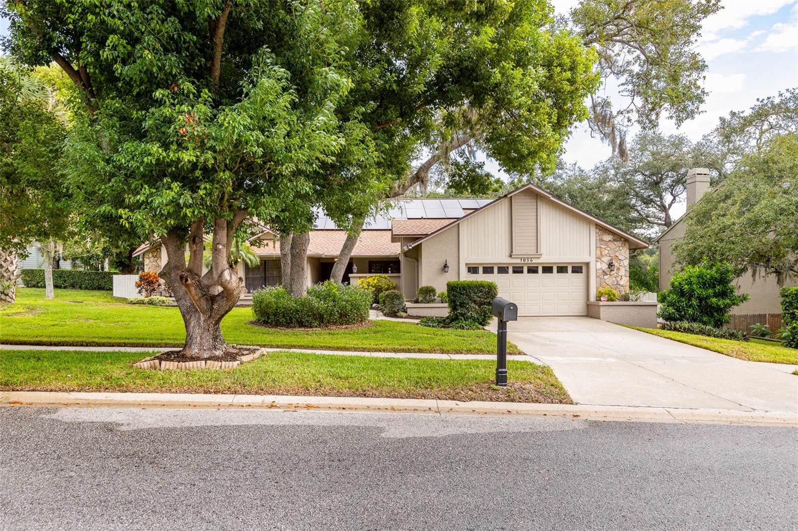 BIG ROOMS, A PRIVATE POOL SETTING AND A FLOOR PLAN WITH SPACE FOR EVERYONE!...... Located in the established Eniswood community and zoned for Palm Harbor Middle and Palm Harbor University High Schools, this substantial 4-bedroom, 3-bathroom home offers 2,813 square feet of living space, high ceilings and the kind of room sizes that are increasingly difficult to find. ……The traditional split-bedroom floor plan provides DISTINCT LIVING SPACES rather than one large open room, giving everyone room to spread out while still offering comfortable areas to gather….A covered courtyard creates a welcoming approach to the double front doors and provides an additional outdoor sitting area just off the formal dining room…. Inside, the foyer opens to a spacious FORMAL LIVING ROOM with high ceilings and direct views toward the covered lanai and pool…... The separate dining room offers a dedicated space for meals, while the kitchen includes a center island, generous cabinetry and an adjoining breakfast nook overlooking the pool…. Just beyond the kitchen, the LARGE FAMILY ROOM makes an immediate impression with its vaulted ceiling, expansive stone wall and WOOD-BURNING FIREPLACE. …..An additional area near the fireplace is already plumbed for a future wet bar, creating even more possibilities for entertaining….. The oversized PRIMARY SUITE occupies its own side of the home and includes plenty of room for a sitting area, along with a substantial bathroom featuring a long double-sink vanity, garden tub, separate shower and toilet room, large walk-in closet and additional linen closet…. On the opposite side of the home, two of the three guest bedrooms measure approximately 16 feet in length and are easily large enough to accommodate KING-SIZE BEDS…. Those bedrooms share a Jack-and-Jill bathroom, while the third full bathroom also functions as a convenient POOL BATH with direct access to the lanai….. Outdoors, the home becomes a true FLORIDA RETREAT. An exceptionally large covered lanai provides abundant shaded space for dining, lounging and entertaining, while the screened swimming pool offers multiple areas to relax both in and around the water. …..The lanai is already plumbed for a future outdoor kitchen, giving the next owner the opportunity to make this impressive outdoor living area even better….. Mature tropical landscaping surrounds the pool and backyard, creating a lush, secluded backdrop with very little visibility toward the property behind... That neighboring home is situated on a substantially larger lot, adding welcome separation between the properties…. Additional highlights include an OVERSIZED 2-CAR GARAGE measuring approximately 650 square feet, a NEW ROOF AND SOLAR SYSTEM INSTALLED IN 2025, HVAC replaced in 2018 and water heater replaced in 2015…. The home offers excellent space, strong architectural features and a highly functional layout, while also presenting an opportunity for the next owner to update the finishes to reflect their own style…. Located in FLOOD ZONE X, where lenders do not typically require flood insurance, Eniswood is a deed-restricted community with a voluntary HOA fee…. Conveniently positioned near Downtown Palm Harbor, Wall Springs Park, the Pinellas Trail, shopping, dining, recreation and the Gulf beaches, this is an opportunity to secure a LARGE PALM HARBOR POOL HOME with impressive room sizes, exceptional outdoor living and the potential to become something truly special.