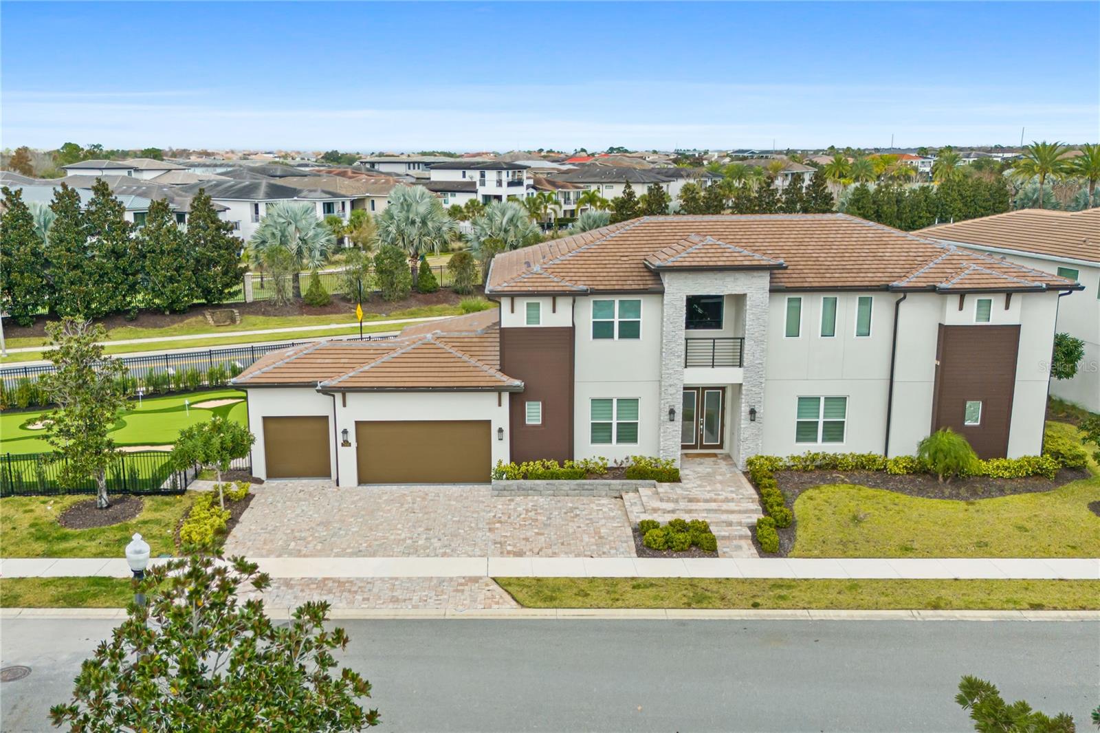 NEWLY UPDATED IN 2026 WITH AMAZING (75 x 42 ft | 3,150 sq.ft) PRIVATE "PUTT PUTT" MINI GOLF. A feature this large is very unique. This luxury resort home is located in the Bears Den Neighborhood of Reunion Resort with active membership. Open floor plan and offers superb gathering spaces for you and family to enjoy. The backyard area is truly exceptional with seating for all your guests lounge around in the Florida sunshine. Dive into the oversized pool or relax in the hot tube with friends. There is space to significantly extend the pool deck to stand out from the competition. This potential upgrade would likely result in greater rental revenue. Reunion Resort is located just 6 miles from Walt Disney World and centrally located to all the other great attractions in the Orlando area. There is currently $71k of guest bookings in place for 2026. Any future bookings after closing would convey to the new owner should they decide to keep the home in the current vacation rental management program. The popular vacation rental has themed rooms that will make families feel like they’re having a one-of-a-kind getaway. The open living area is a great gathering spot for the family to enjoy each other's company with comfortable seating including a leather sectional overlooking the private pool deck as well as a feature fireplace. The fully equipped kitchen offers a four-seat breakfast bar and a dining table for seating up to twelve for a meal at any time of day.  This home can accommodate up to 16 guests, providing plenty of space with two king-sized suites on the bottom floor and an additional king-sized bedroom with a shared family bathroom adjacent. On the second floor, you will find a further king-sized suite, a superhero-themed bedroom with two sets of bunk beds (4x twins) and a connecting bathroom as well as a candy-themed bedroom with two sets of bunk beds (4x twins) and a connecting bathroom.  Once you get to the loft area on the second floor, you will be amazed by all its entertainment with a pool, foosball, and air hockey table for plenty of entertainment as well as a video game-themed games room equipped with arcade games and a home theater with a large flat-screen TV. The outdoor deck offers a private swimming pool and spillover spa to enjoy Florida's warm weather as well as a summer kitchen for all your grilling needs and a fire pit. The home gym also allows for some exercise and relaxation while on vacation.