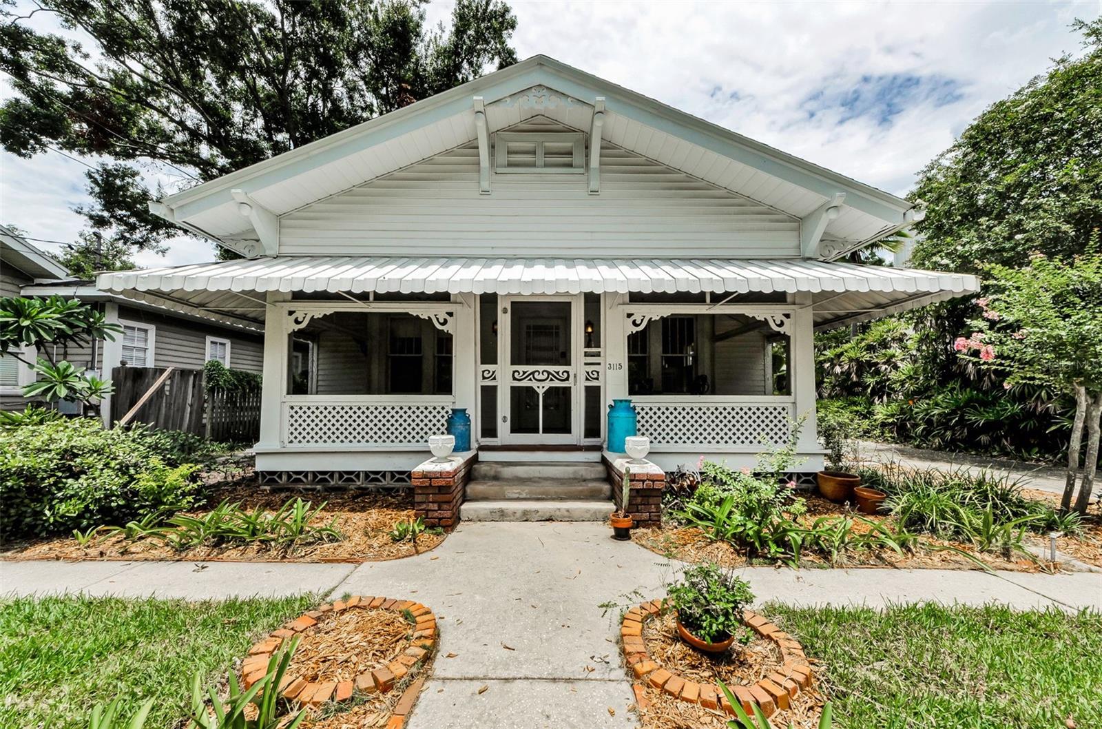 Under contract-accepting backup offers. **NEW PRICE!**Step into a piece of Tampa history with this 1926 Craftsman Bungalow nestled in the highly sought-after Bayshore Beautiful neighborhood. This well-preserved home contributes to the architectural tapestry of Bayshore Beautiful, where historic homes sit gracefully alongside modern luxury builds. From the wide front porch to the Porte-cochère every detail reflects the era’s artistry and intent. Great Curb Appeal with Beautiful Tropical Landscaping. Inside, the home showcases exquisite original millwork, from carved wood trim and crown molding to decorative cabinetry and hand-carved accents. Lots of windows make this home light and bright. Graceful columns with built in cabinets frame the passage between the spacious living room with a wood-burning fireplace—and the large formal dining room, which is adorned with the original brass chandelier. The kitchen features wood cabinetry with artistic detail, a closet pantry, and a distinctive Italian chandelier, while the original checkerboard flooring adds vintage flair and 1920s drama. A bonus room off the kitchen houses a built-in drafting table, a laundry closet with stackable washer/dryer, and direct access to the carport. The primary bedroom includes a walk-in closet and an adjacent bonus room with a charming potbelly wood-burning stove and built-in shelving—could be used as a 3rd bedroom, and perfect as a reading room, office, or cozy retreat.  The spacious bathroom showcases what is likely the original cast iron alcove tub with shower, a single vanity, and a decorative stained-glass window that casts soft lighting into the room.  PROPERTY HIGHLIGHTS INCLUDE: NEWER ROOF (2023), HVAC (2015), Original Oak Hardwood Floors, All Original Windows, Old-Growth Doors with Original Crystal Knobs, Wood Cabinets, Plaster Walls, A Detached Storage Shed, Preserved Light Fixtures. This timeless gem is more than a home—it’s a rare opportunity to own a thoughtfully maintained piece of Tampa’s past, full of soul, character, and enduring craftsmanship.
 Located in the heart of Bayshore Beautiful—one of South Tampa’s most cherished historic neighborhoods. Just minutes from iconic Bayshore Boulevard, you’ll enjoy scenic walks, bike rides, and stunning views of Tampa Bay. The community is known for its tree-lined streets, walkability, and architectural character.  Nearby Ballast Point Park & Pier, The Stovall House, Tampa Yacht Club, Bern’s Steak House, Bars & Nightlife at Hyde Park, SoHo, and Palma Ceia Neighborhood & Country Club....this upscale neighborhood is home to fine boutiques, café-lined streets and top-tier golf and social amenities.  International Plaza & Bay Street, Downtown Tampa (12 mins),  You’ll also find a vibrant mix of coffee shops, cafés, boutique fitness studios, and neighborhood markets nearby. With easy access to MacDill Air Force Base, Downtown Tampa, and top-rated public and private schools, this location offers a lifestyle that’s both relaxed and refined—perfect for those who appreciate history, community, and convenience. **No flood insurance required, one of south Tampa's highest elevations.** *Do not miss this opportunity! Call today!*