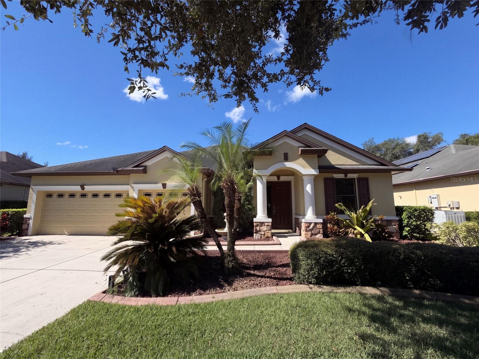 20009 Outpost Point Dr is a two-story Tampa home with four bedrooms, four bathrooms and over 2,900 sq ft of living space. The kitchen’s center island has a raised seating counter and opens to the main living area, where sliding doors lead to a covered rear patio. The main-level primary bedroom has a bay-shaped window wall and an adjoining bathroom with two sinks, a separate tub and shower, and a walk-in closet. A separate front living room and office add distinct spaces on the main level. Upstairs, a bonus room has its own full bathroom. Included 100-Day Home Warranty with buyer activation
