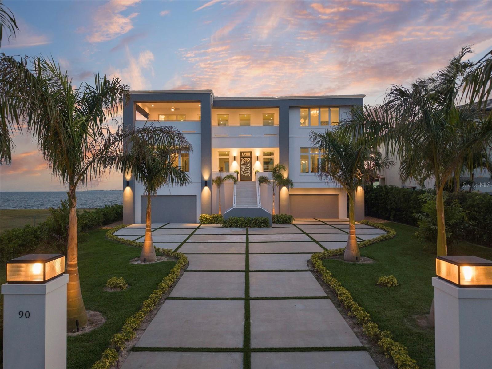 Introducing Oceara, a landmark of bold design, superior engineering and refined coastal living on Tampa’s Billionaires Row in Davis Islands. Built by renowned Alvarez Homes and completed in late 2024, this architectural fortress is constructed of poured concrete and steel, elevated to meet FEMA codes, anchored by 40-foot-deep pilings driven to bedrock, and topped with a riveted metal roof and full-impact glass throughout. Go inside to a grand double-height foyer, grounded in architectural sophistication, with a floating glass-and-metal staircase revealing uninterrupted water views of Tampa Bay. Oceara features six luxurious private suites, a game room, elevator, and an expansive garage accommodating eight or more vehicles. Designed to embody enduring strength and contemporary design, the home offers oversized covered balconies that invite year-round enjoyment of outdoor living in the gentle coastal breeze. Set on Davis Islands, a self-contained island offering everyday essentials, charming cafes and home to Tampa General Hospital. This golf cart community also features a marina, beach, dog park and convenient access to the nearby Davis Islands Airport. Just minutes from downtown Tampa, Oceara combines ultimate luxury with rare accessibility. The resort-style pool, like the home itself, is supported by deep pilings for lasting peace of mind. From sunrise to sunset, Oceara redefines elevated waterfront living. This home is one of one, like you. Make it yours. Sold furnished. Over 12,000 SqFt under roof, including two rear covered balconies (44' x 12') and a front balcony (approx. 20' x 12'). 100+ feet of concrete seawall.