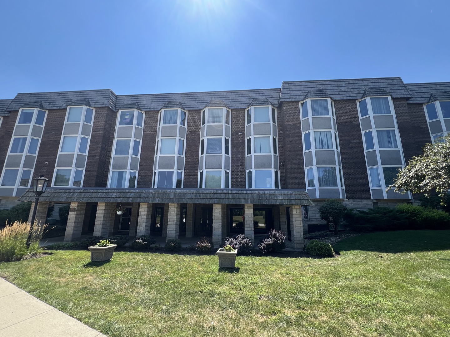 Updated desirable corner unit at popular, affordable Bristol Court. Convenient location on beautiful grounds, surrounded on 2 sides by forest preserves. Deluxe updates include kitchen with cherry cabinets, open to dining room. Remod. baths with ceramic tile floor and walls, vanities with solid surface tops. Second bedroom currently furnished as family room/office with double French doors and wall of built-in custom storage cabinets and desk area. Custom window treatments throughout. Shows like model!