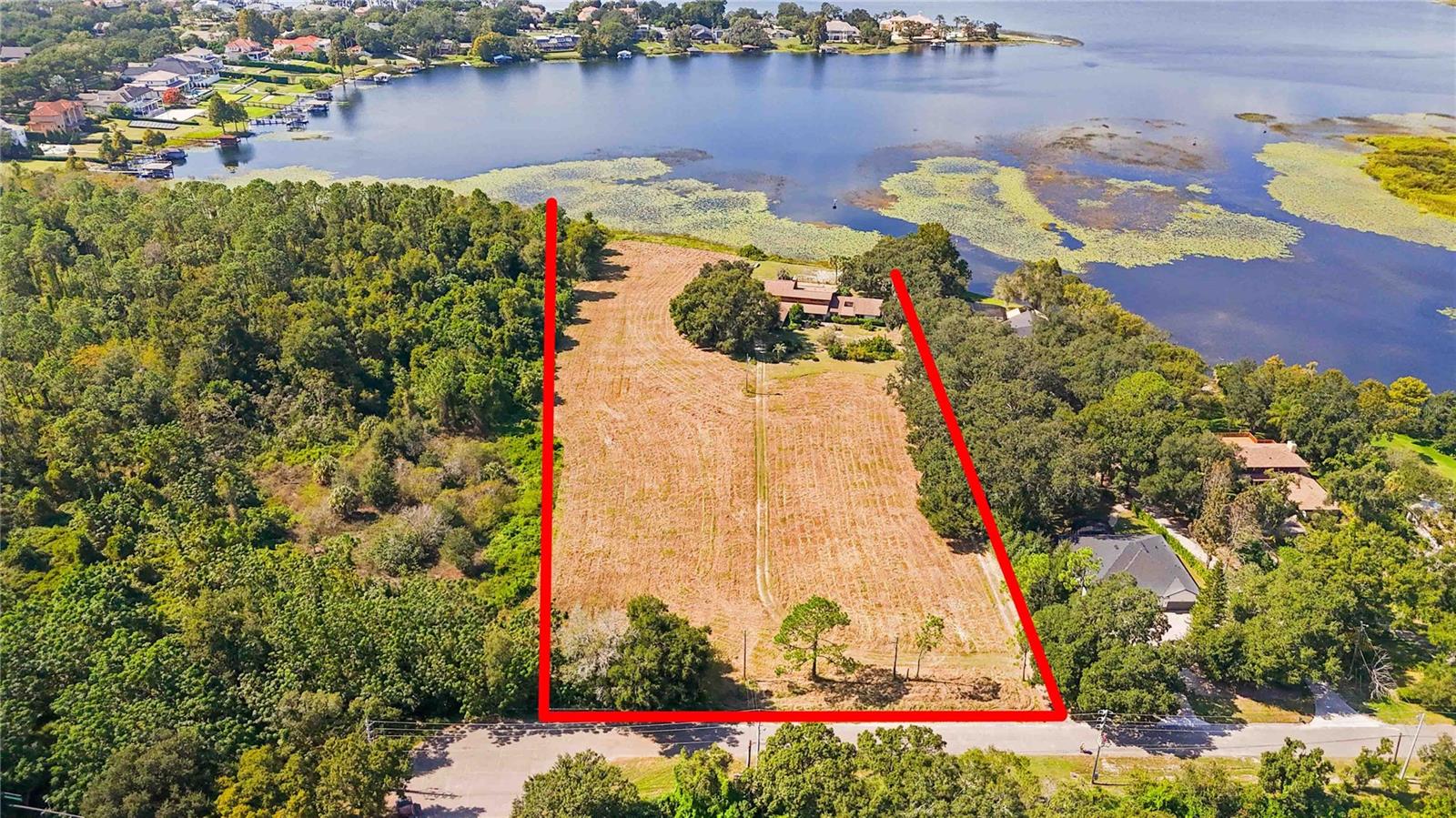 Exceptional DEVELOPMENT OPPORTUNITY, currently R-CE zoning should allow for 3 Lakefront Luxury Home Sites Discover over 5+acres of waterfront land with 300 feet of pristine shoreline on LAKE DOWN, part of the coveted BUTLER CHAIN of Lakes. This is a rare chance to create a premier LAKEFRONT ESTATE or subdivide to create three ideally sized lots with WATER FRONTAGE. At present, the property includes an older 5,000 sq ft home (5 bedrooms, 3.1 baths) and an oversized four car garage, which can serve as a temporary residence or teardown to make way for your vision. Why this property stands out, Unmatched location: Situated on the east side of Windermere, with convenient access from Conroy Windermere Road and Apopka Vineland. Windermere prestige, Offers the cachet of a WINDERMERE ADDRESS and proximity to luxury amenities. Prime access: Minutes to Isleworth Country Club, Bay Hill, and downtown Windermere. Development upside: Ready canvas for luxury estates in one of Central Florida’s most desirable waterfront corridors. Whether you’re a developer, custom builder, or investor, this is your opportunity explore and deliver truly exceptional homes in a highly sought-after market. Property is also listed as residential MLS # O6355233