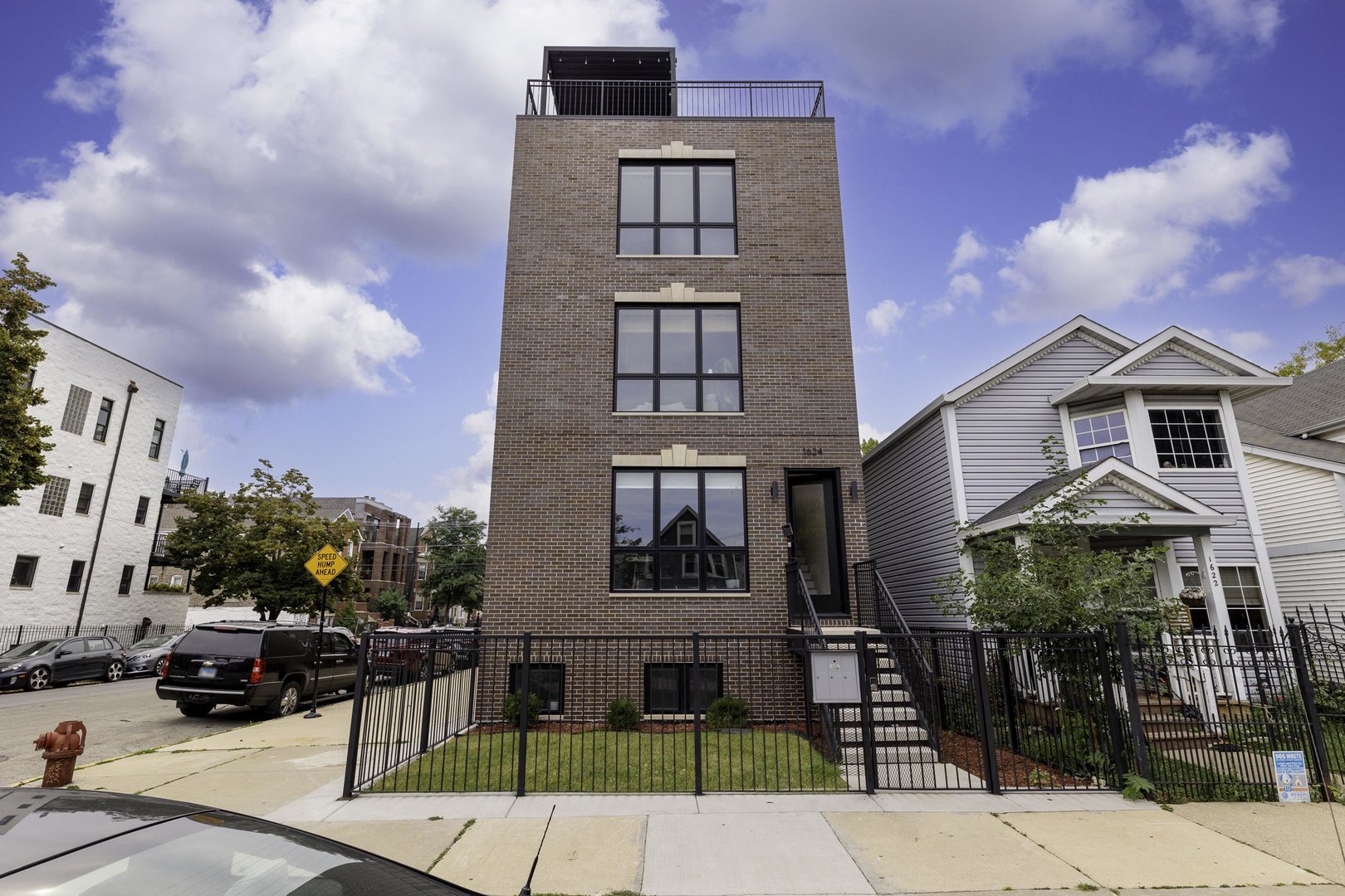 Welcome to this stunning 2-bedroom, 2-bath penthouse in the heart of Pilsen! Built in 2023, this modern home is flooded with natural light from windows throughout and offers a bright, airy open floor plan with tall ceilings. The sleek kitchen boasts flat-panel cabinetry, quartz countertops, a full backsplash, and premium LG appliances. The spacious primary suite includes dual walk-in closets and a luxurious bath with dual vanity and separate shower. Additional features include in-unit laundry, carport parking with EV charging capability, and both a large rear deck and a private rooftop deck. The rooftop is an entertainer's dream, equipped with a Fusion Flame outdoor kitchen, steel louvered pergola, and panoramic city views. Perfectly situated on a corner building, just steps from the vibrant dining, cafes, and shops of 18th Street, as well as the Pink Line and the National Museum of Mexican Art. A truly modern and bright home in one of Chicago's most dynamic neighborhoods!