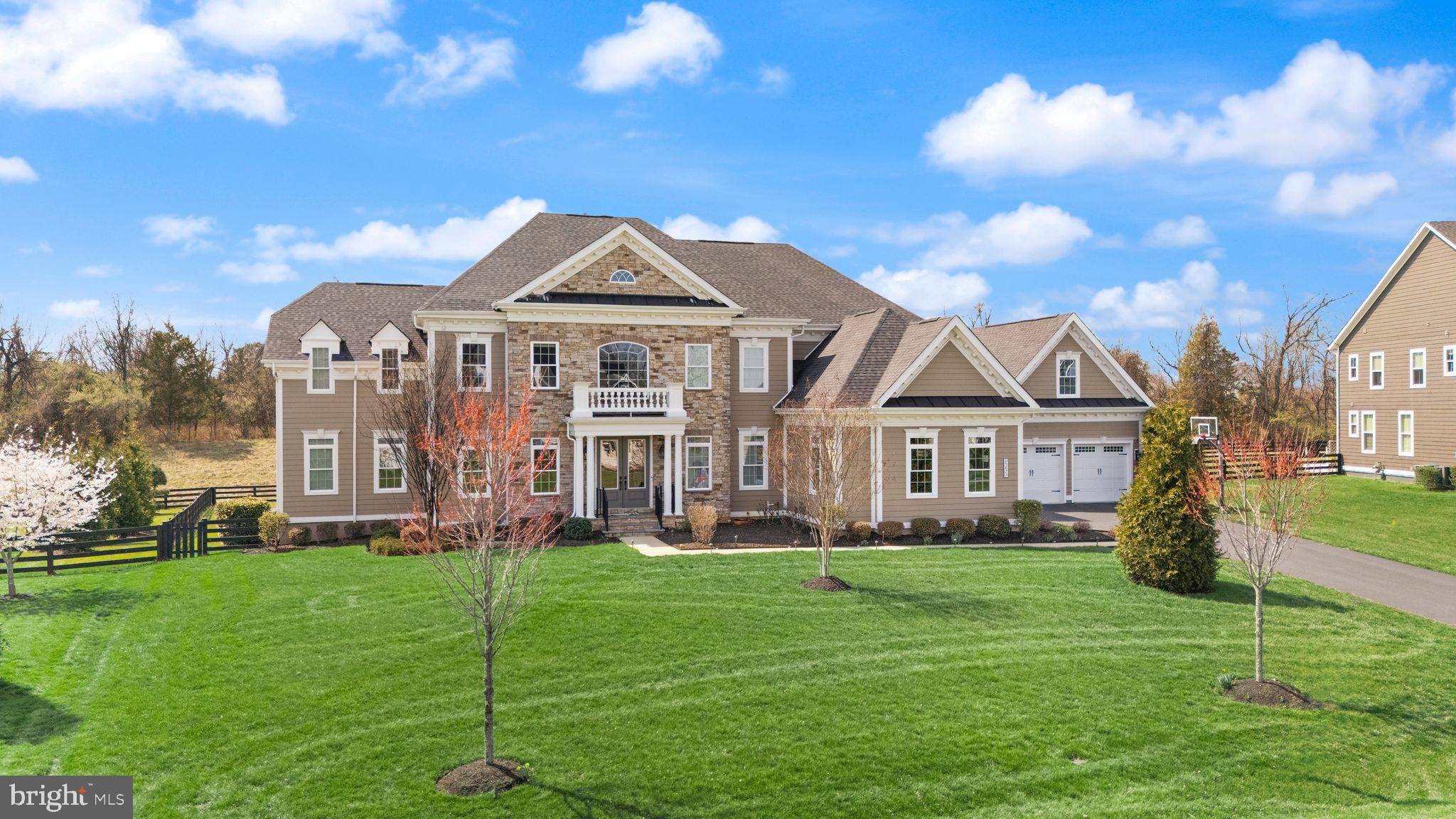 Welcome to the jaw-dropping Clifton Park II, perfectly positioned in the prestigious Willowsford – The Greens, where timeless elegance meets modern luxury, with every detail thoughtfully curated to captivate even the most discerning buyer.From the very first moment, this residence makes a powerful impression. A grand 4-car garage equipped with 2 EV chargers sets the tone for elevated living, while the thoughtfully designed Friendship door entry creates a seamless flow between the garage, mudroom, second private office, and the heart of the home—offering both convenience and sophistication rarely found.Step inside, and you are immediately embraced by a sense of arrival. A majestic, magazine-worthy staircase rises gracefully, setting the stage for what unfolds within. To the left, an elegant sitting area invites meaningful conversations and refined gatherings, while to the right, a formal dining room awaits unforgettable dinners and celebrations. Just beyond, a beautifully appointed wine bar perfectly bridges the dining space and kitchen—designed for effortless entertaining.At the heart of the home lies a recently updated chef’s kitchen, a true statement of style and function. Featuring two oversized islands, top-of-the-line appliances, two sinks, two dishwashers, and a custom hood,  this space is both breathtaking and brilliantly designed. It flows seamlessly into the dramatic two-story family room, where walls of windows flood the space with natural light and offer a stunning gallery view from above.The main level continues to impress with two private offices, ideal for today’s lifestyle, along with a guest suite with a full bath, an additional powder room, and a well-appointed laundry room. From here, step outside to an extraordinary outdoor retreat.The backyard is a true sanctuary, crafted for both grand entertaining and peaceful everyday living. A Flagship stone patio, built-in grill, and outdoor kitchen anchor the space, while a pergola-covered dining area creates the perfect setting for al fresco evenings. Surrounded by a lush, fenced lawn and open views, this outdoor experience feels both private and expansive.Upstairs, luxury continues with five exceptionally spacious bedrooms, each offering its own private ensuite bath and walk-in closet, ensuring comfort and privacy for every member of the household. The primary suite is a retreat of its own—generously sized, featuring an enormous walk-in closet and a spa-inspired bath complete with a jetted tub, oversized shower, and dual vanities designed for indulgence.The fully finished lower level elevates the home into a complete lifestyle experience. Designed for entertainment and relaxation, it features a full wet bar, a dedicated media room, a bonus room, a play area, and an additional bedroom with a full bath. A walk-up staircase provides seamless access to the backyard, enhancing both function and flow.Perfectly facing northeast, this home aligns beautifully with principles of light, energy, and harmony—an element deeply appreciated by those seeking not just a home, but a space that feels right in every sense.This is more than a residence—it is a statement. A home where luxury, comfort, and thoughtful design converge to create an extraordinary living experience in one of the region’s most sought-after communities.Willowsford Amenities️ Outdoor & Nature40+ miles of trails across all villages (Greens, Grove, Grant, Grange)Lakes & ponds (Willow Lake, Pin Oak Pond)Kayaking & canoeing on Willow LakeScenic farmland, meadows & preserved open spaceCampground (Grant Family Campground) Clubhouses & Gathering SpacesThe Lodge at Willow LakeSycamore House (signature event venue)Bear Barn Tree HouseWhite Oak Tree HouseLog Cabin Tree HousePavilions & reservable event spaces Pools & Water FeaturesResort-style pools (Sycamore Pool, Lodge Pool)Splash parks / Spray-n-Play areasWillow Lake recreation area And Much MORE!!!