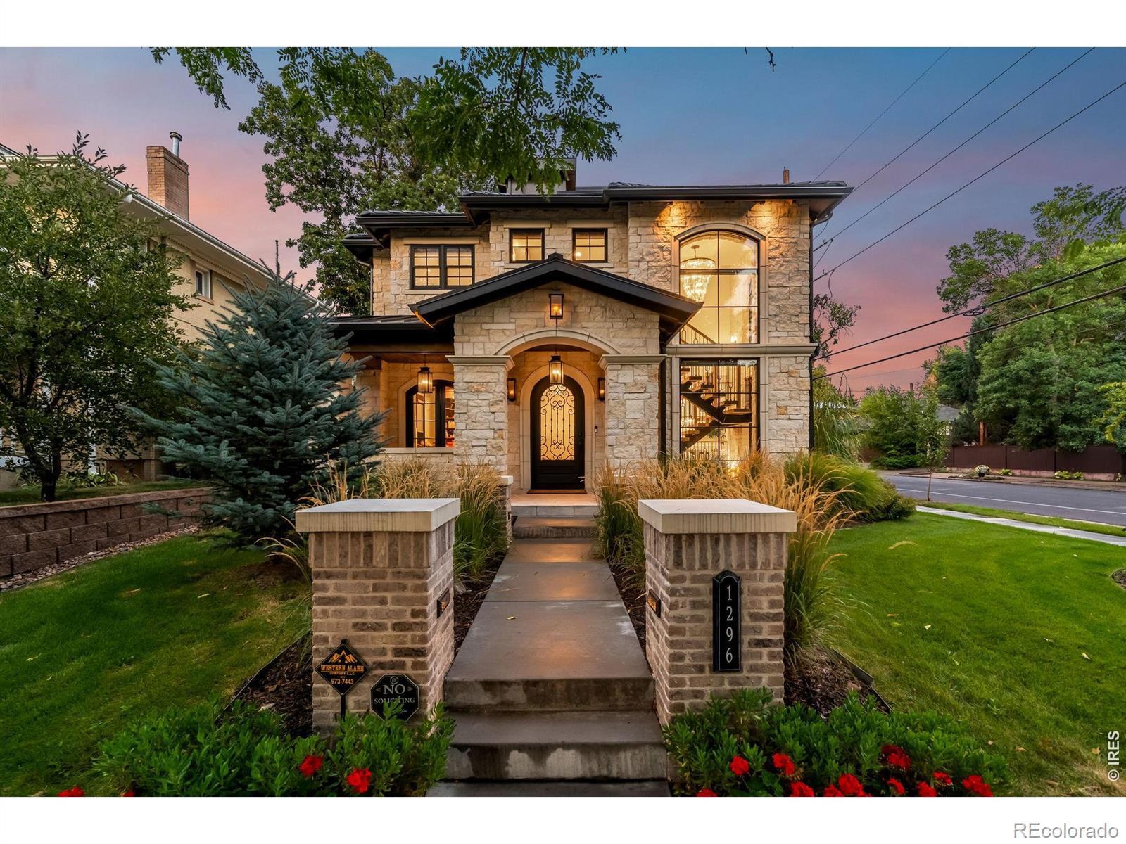 Striking modern architecture meets elevated functionality in this East Wash Park stunner, designed for those whoappreciate luxury, space, natural light, and architectural detail. Situated on a prominent corner lot just blocks from SouthGaylord Street, this limestone residence blends architectural presence with refined modern living. Spanning over 6,000square feet, the home is defined by dramatic lines, custom craftsmanship, and walls of glass that dissolve the boundarybetween indoors and out. The main level showcases 10-foot coffered ceilings, a statement floating staircase, and seamlessindoor-outdoor flow to a covered patio with overhead heating and built-in gas fireplace. The kitchen features Sub-Zero andWolf appliances, dual quartz islands, and thoughtful custom cabinetry. Upstairs, four bedrooms include a serene primarysuite with steam shower, soaking tub, walk-in closet, and built-in morning bar. A third-floor flex suite with full bath opensto a west-facing rooftop deck with skyline views-ideal for guests, au-pair, home office, gym or party room. Downstairs,11-foot ceilings elevate the fully finished basement, which offers a large recreation room, wet bar, gym, guest bedroom,and full bathroom. Originally completed in 2021 by respected local luxury builder Cline Design Group, the home has sincebeen elevated with over $200,000 in upgrades including bespoke window coverings throughout, a fully integrated AV andControl4 smart-home system, and a Culligan whole-house water filtration system with reverse osmosis. 240V outlet in theoversized garage provides EV charging capabilities. Every detail, such as the full limestone exterior facade and cement tileroof, speaks to quality and intention, offering a residence that balances timeless design with contemporary sophisticationin one of Denver's most established neighborhoods.