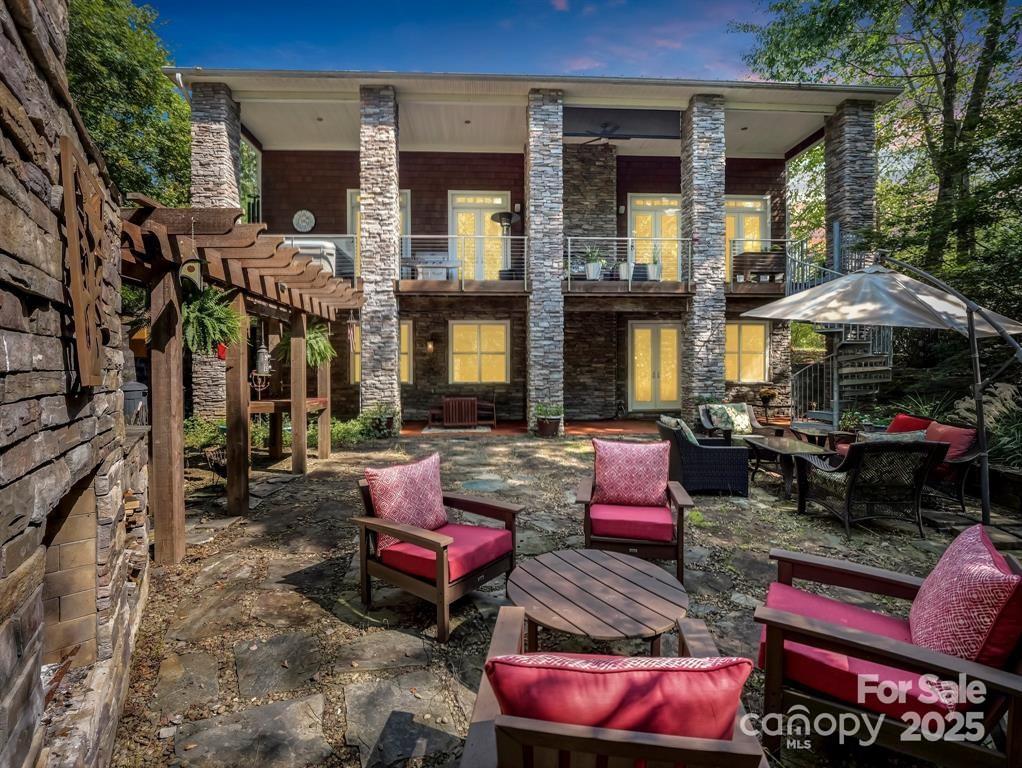 A must see to truly appreciate!  Pride in ownership along with peace and tranquility await you in this one-of-a-kind cedar shake & stone custom built home that was designed by the current owner/architect. Open 2-story floor plan w/beams, lots of natural light & unique appeal.  Main level has maple hardwood floors, high-end 'Monogram' appliances, granite countertops, cherry cabinets & KIT island that makes way for a chef's dream. GR has see-thru gas FP to exterior 'Eon' decking which has a hot tub and great view of outdoor entertaining area. Primary en-suite has 18'+ vaulted ceiling, custom sliding door, 2 walk-in closets, tile shower & laundry room. 2nd level features cork floors, huge loft w/'link' to full bath and guest suite complete w/counter, sink & fridge. Lower level has a bar, FP, full BA, storage, flex space to suite your style and walk-out to stone patio to outdoor FP & established landscaping. Top all this off w/a 3-story elevator for ease of living along with a whole house generator that keeps the household humming. Private outdoor space w/2 fireplaces, pond & trails on 2 acres. Tons of storage throughout and if that isn't enough, you've got a fabulous oversized dbl garage with heated & cooled workshop.