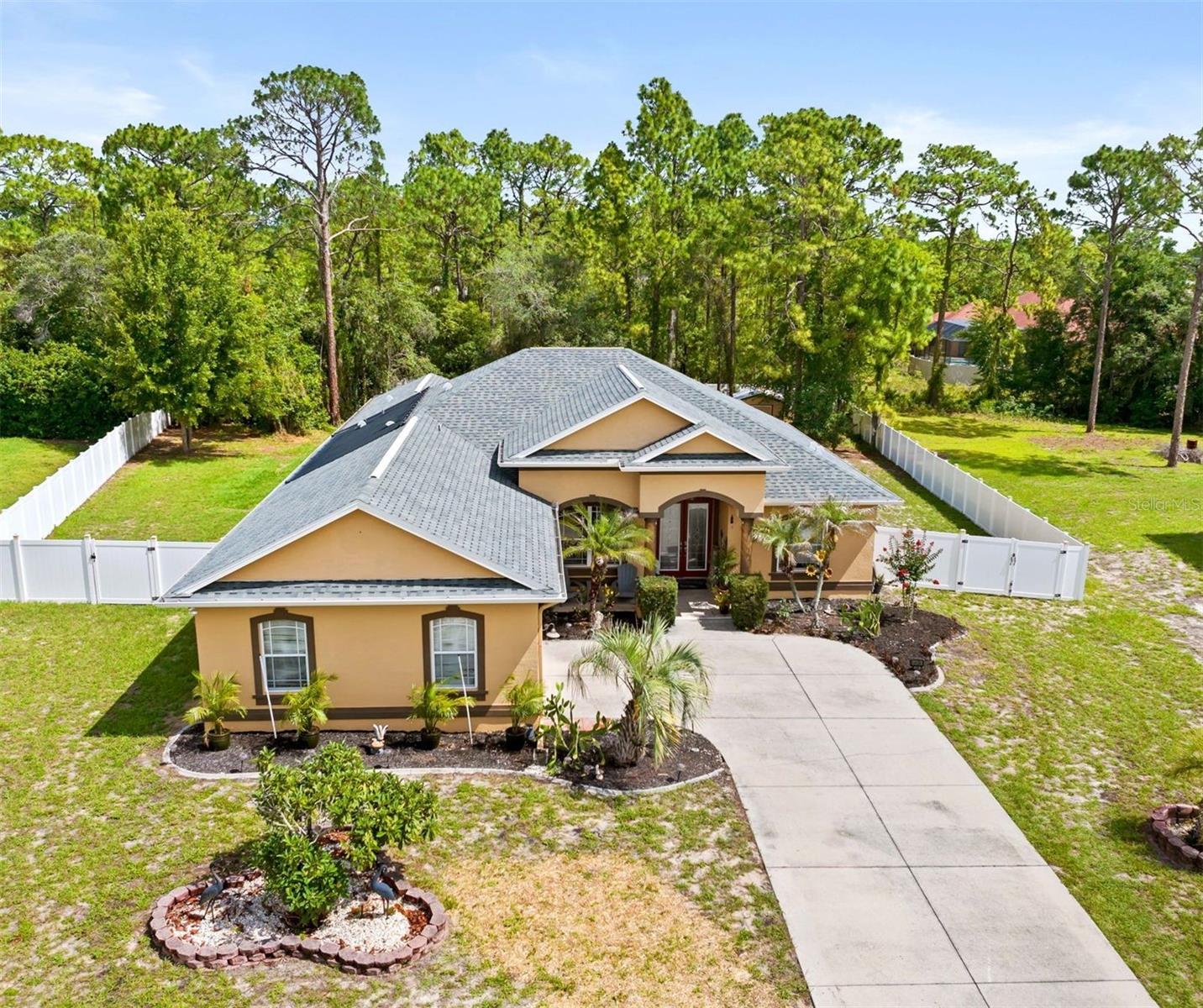 Welcome to your ultimate private oasis! Nestled in a quiet, peaceful neighborhood with NO HOA, this beautifully updated 3-bed, 3-bath, 3 car garage retreat sits on nearly an acre of land, perfectly blending suburban solace with resort-style luxury. Crafted for urban dwellers seeking a peaceful escape, growing families needing space, and entrepreneurs looking for a home that doubles as an inspiring live-work sanctuary, this property truly has it all.Experience true Florida living with two massive living spaces featuring quad pocket sliders that completely tuck away, opening your home entirely to a spectacular outdoor entertaining area. Step outside to your private paradise featuring an inground pool with a tranquil fountain and an outdoor fireplace perfect for hosting unforgettable gatherings under the stars.Inside, a thoughtful split floor plan provides maximum privacy for the primary suite, while the versatile second living space is limited only by your imagination—perfectly suited as a high-tech media room, dedicated home office, private mother-in-law suite, or an expansive fourth bedroom. Complete with freshly updated paint throughout and a massive 3-car garage offering abundant storage for vehicles, weekend toys, or a dedicated home workshop, this home delivers an unparalleled lifestyle. Whether you are looking to escape the city bustle, give your family room to grow, or run your business from a peaceful, retreat-like setting, this home delivers. Big ticket items -New paint throughout, roof with transferrable warranty replaced in 2024, new solar heater for pool with 10-year warranty, A/C 8 years old with new condenser, and hookup for generator! Schedule your tour today!