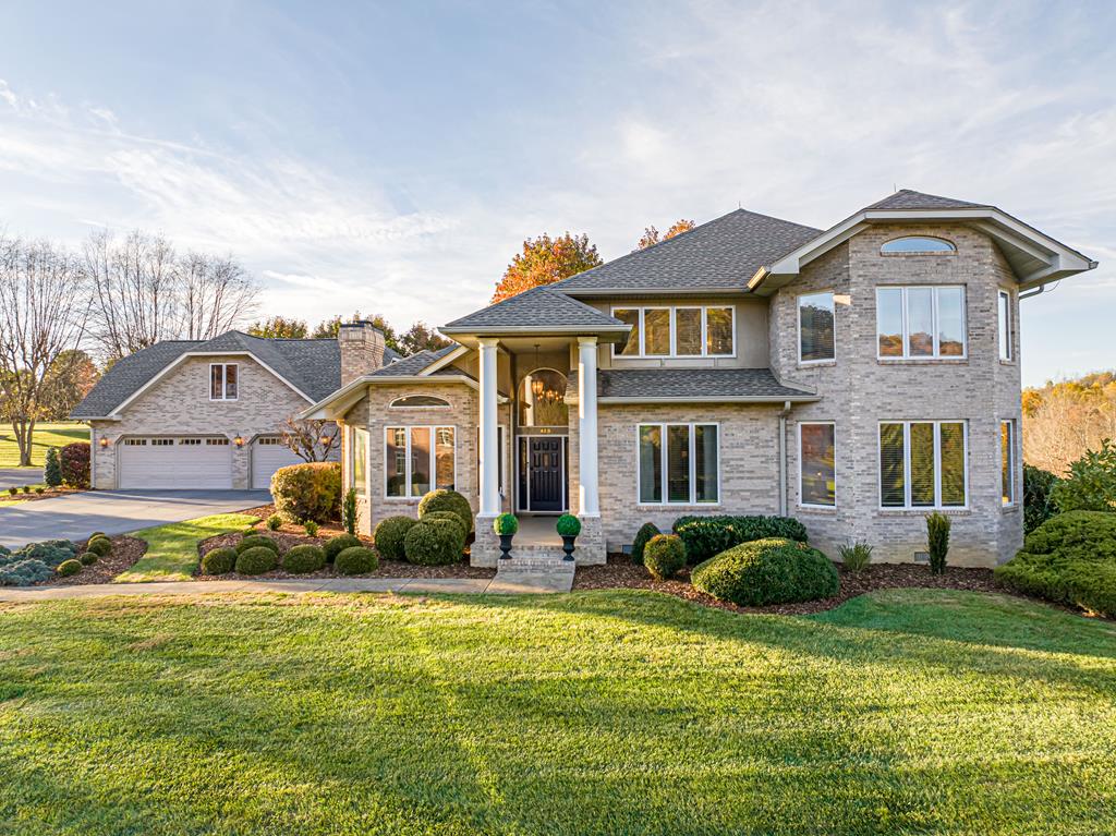 469 Winterham Drive welcomes you with exceptional curb appeal, beautifully landscaped grounds, & views overlooking the #8 tee box of Glenrochie Country Club. Just steps from The Virginia Creeper Trail, this setting offers both beauty and convenience. In 2022, the home underwent a major renovation, including a redesigned kitchen and baths, new flooring, roof, lighting, and paint—showcasing thoughtful attention to quality and detail throughout. A striking two-story great room serves as the home's centerpiece, offering a bright, airy space for relaxation & entertaining. The chef-inspired kitchen features updated appliances, ample cabinetry, & a charming breakfast nook, while the elegant dining room provides the perfect setting for family meals or special occasions. A cozy family room shares a double-face fireplace with the great room, creating an inviting atmosphere for gatherings. The main-level primary suite is a true retreat, featuring 2 walk-in closets & a spa-inspired bath with a soaking tub, walk-in shower, custom cabinetry with designer lighting. Upstairs, 2 generously sized bedrooms share a Jack & Jill  bath, while a third bedroom & additional full bath offer comfort & privacy for family or guests. The main-level laundry room leads to a private office and a flexible lounge, art studio, or fitness space to fit your lifestyle. Outdoor living is just as impressive, with lush landscaping that creates a serene backdrop for entertaining, gardening, or relaxing in the hot tub. Access to the garage, kitchen, covered patio, and driveway flows seamlessly through a convenient breezeway/mudroom—ideal for everyday coming & going or unloading groceries w/ ease. The covered patio provides a separate entrance to a versatile private living area above the three-car garage—perfect for an in-law suite, home office, or guest quarters. Additional highlights include dual driveways & the peace of mind of a new roof installed in 2022. 469 Winterham Drive is ready to welcome you home.