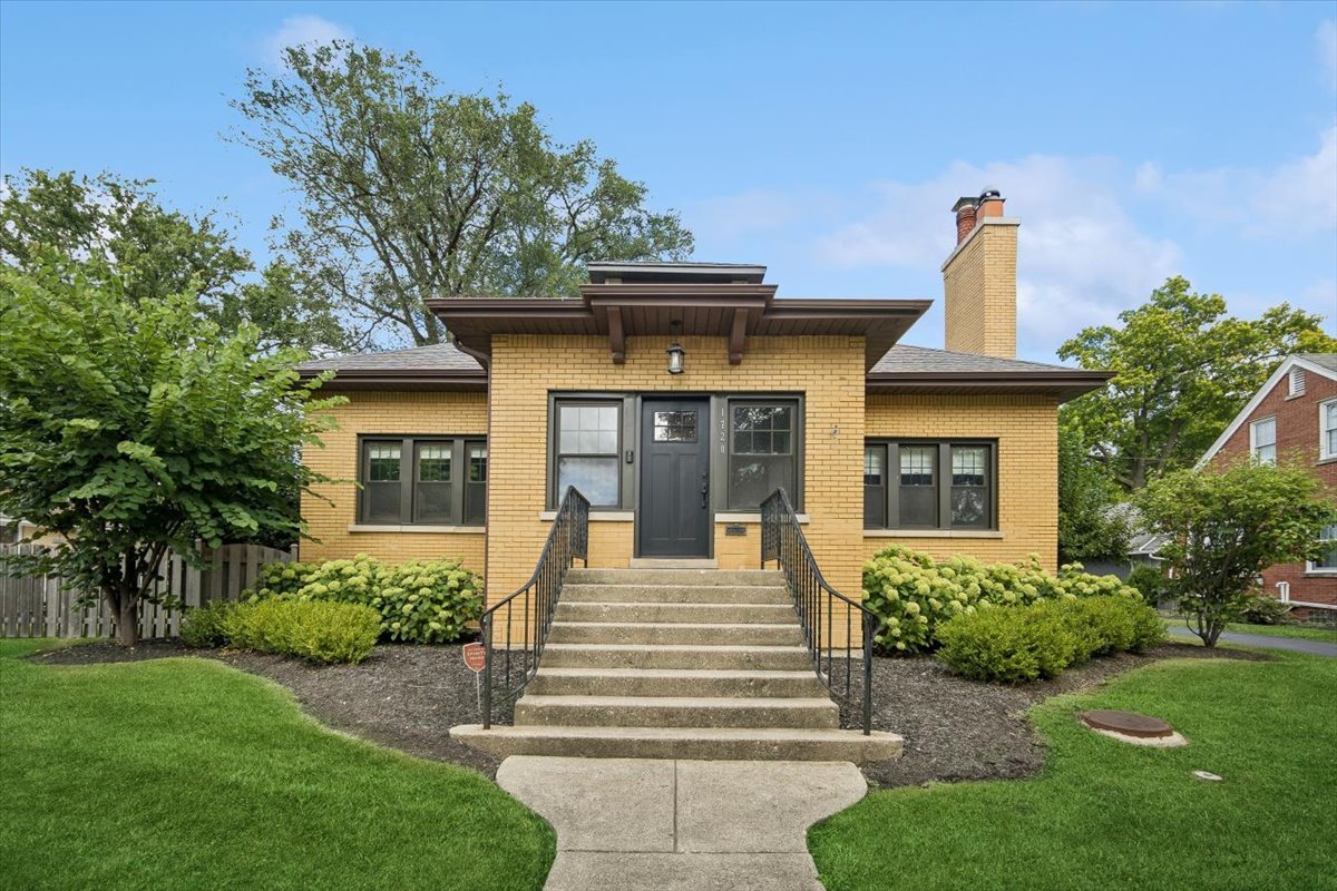 Welcome to 1720 Greendale Avenue - a timeless Park Ridge gem set on an expansive double lot. This beautifully maintained 5-bedroom, 3-bath brick home offers the perfect blend of character, space, and versatility-made even more rare by its oversized property. The main level features two spacious bedrooms and a full bath, along with a bright sun-filled office, elegant formal dining room, and inviting living room with a cozy gas fireplace. High ceilings, crown molding, and arched doorways add to the home's classic charm, while the oversized kitchen-with its large center island, granite counters, and abundant cabinetry-provides the perfect gathering space. Upstairs, three additional bedrooms and a full bath create plenty of room for family and guests. The lower level offers exceptional flexibility with a full bath, kitchenette, and workout room-ideal for an in-law suite, teen retreat, or entertaining hub. Outdoor living is where this home truly shines. The rare double lot allows for a spacious backyard with a large patio, green space for play and gardening, and an oversized 3-car garage with ample driveway parking. Both front and back entries serve as practical mudroom-style spaces, keeping the home organized for busy households. Located in sought-after Park Ridge, close to top-rated schools, parks, shopping, and transportation, this home combines size, function, and location-making it a true standout.